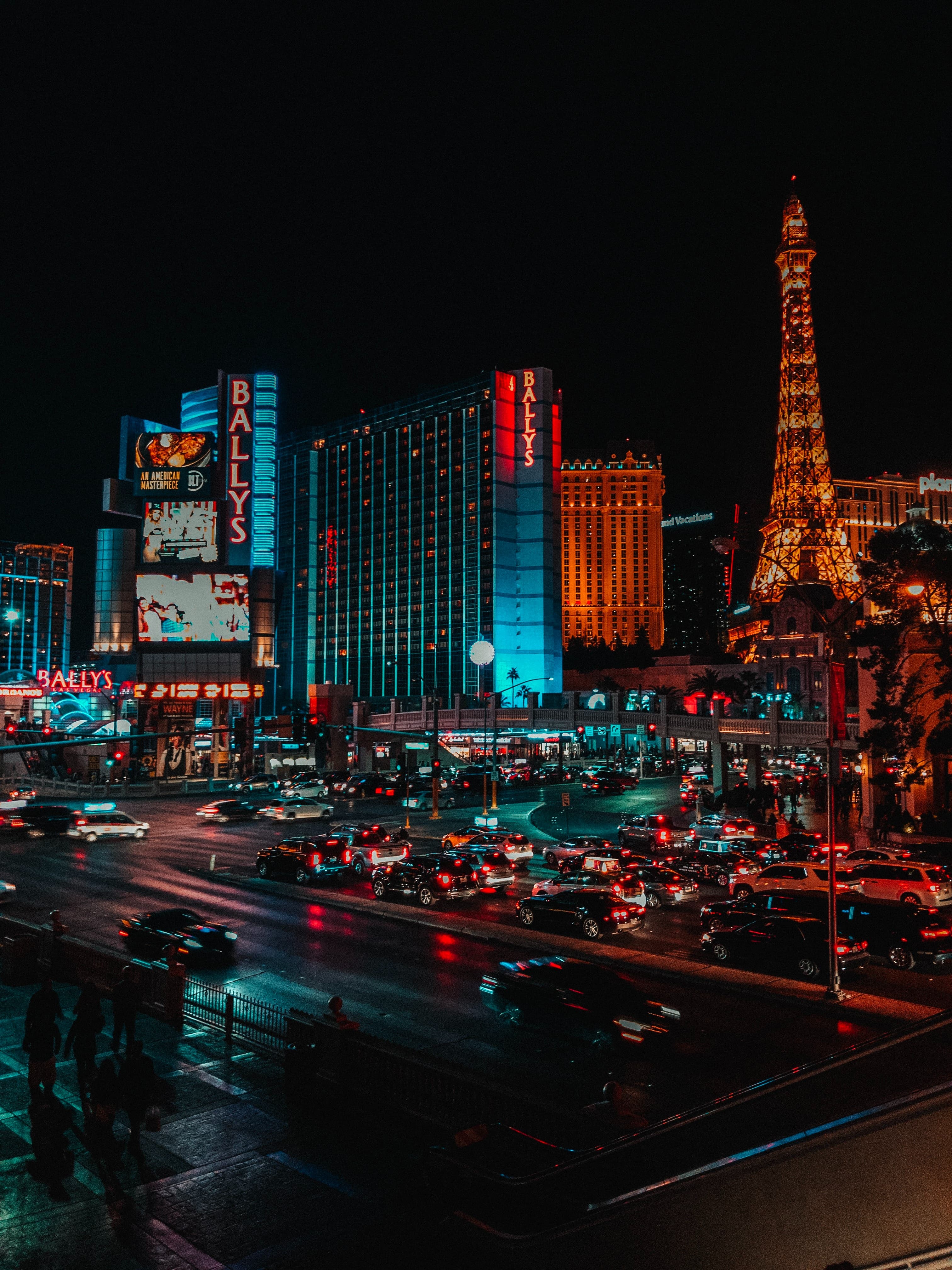 Night view of Las Vegas with high rise buildings, streets, traffic and lighting.