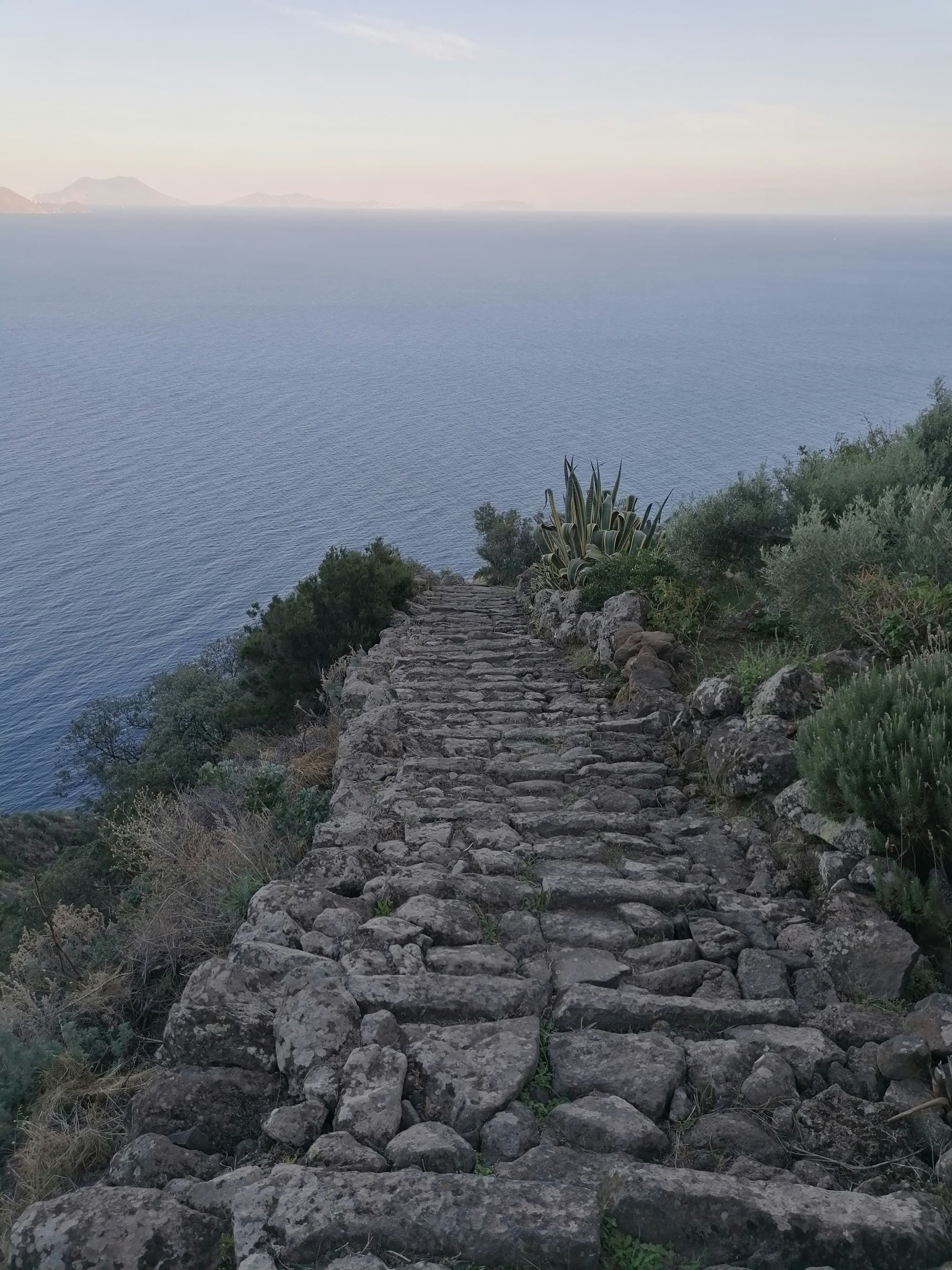 A stair case towards sea during daytime.