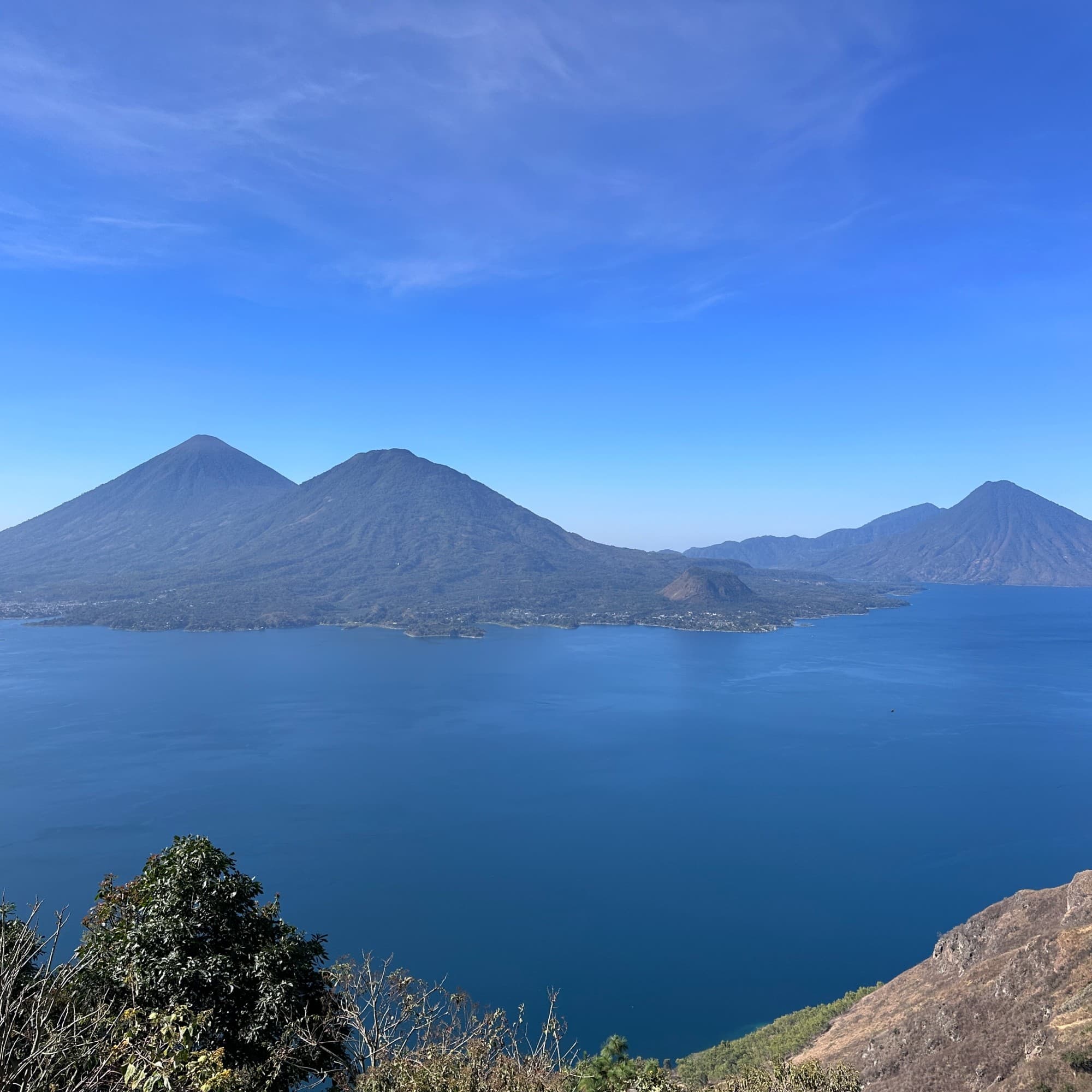 A lake with mountains during daytime.