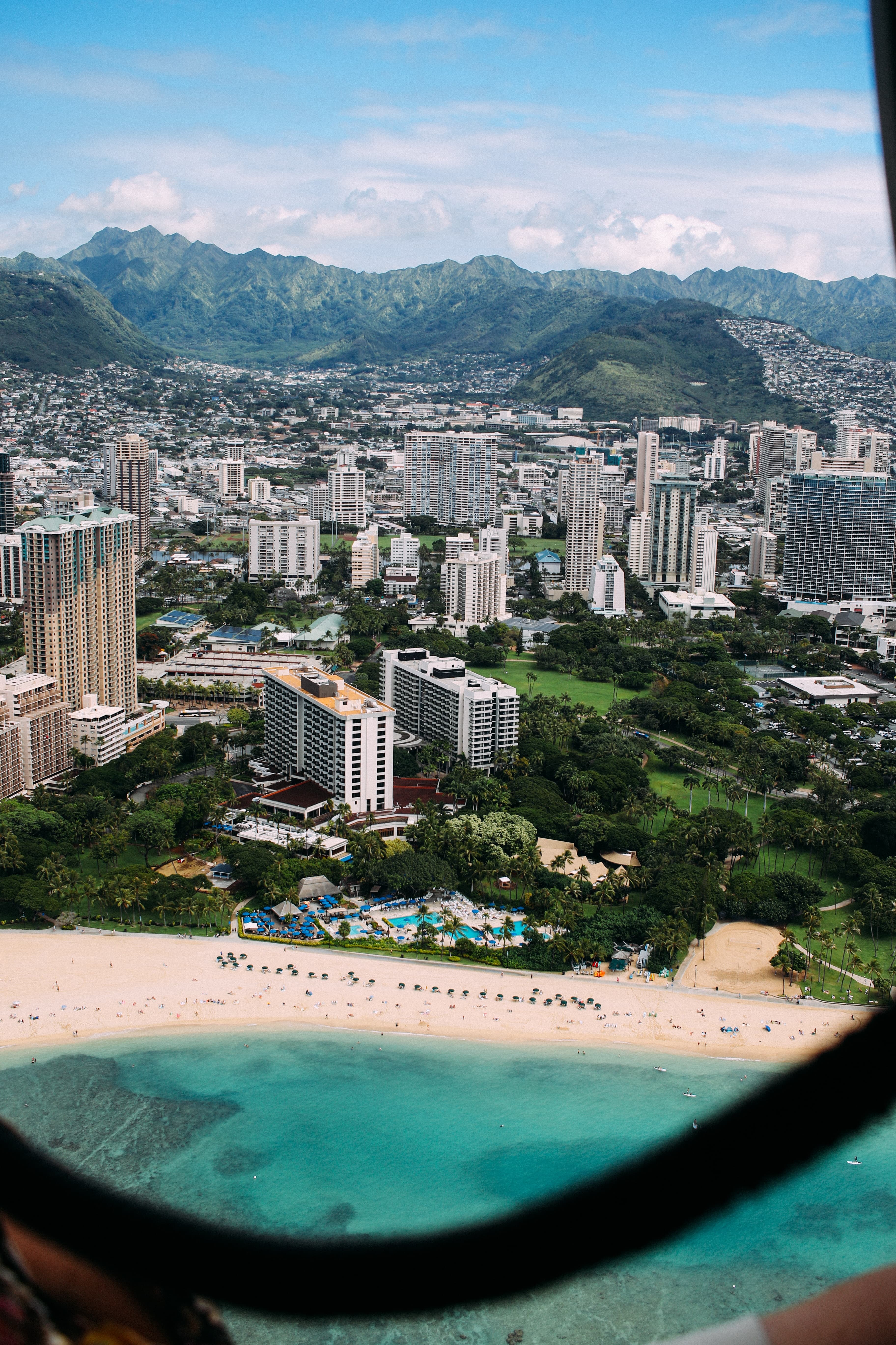 city skyline next to body of water and beach during daytime