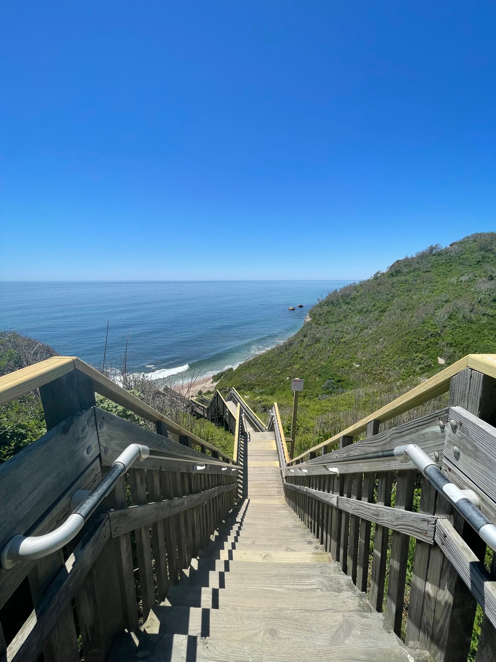 wooden staircase down to ocean