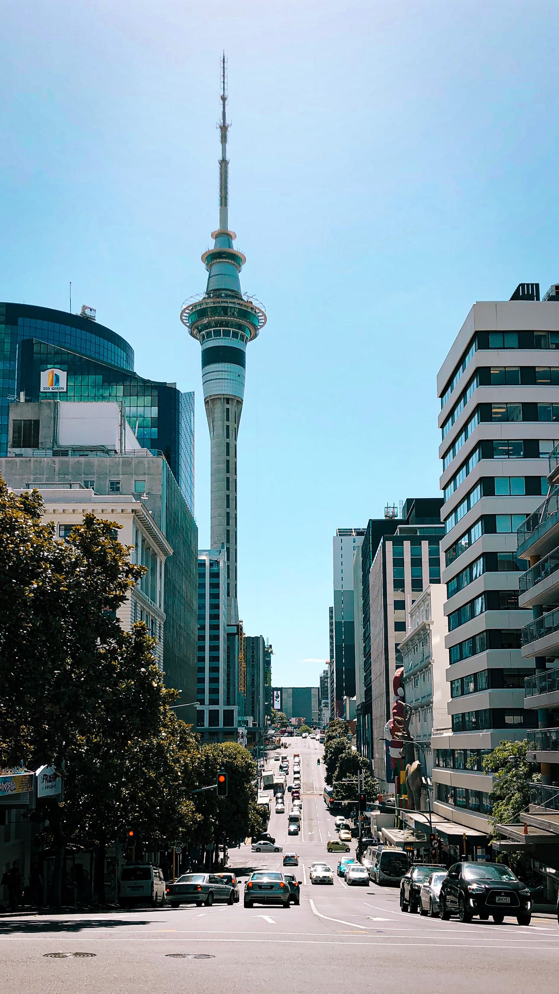 City with buildings and road with cars with clear skies during daytime