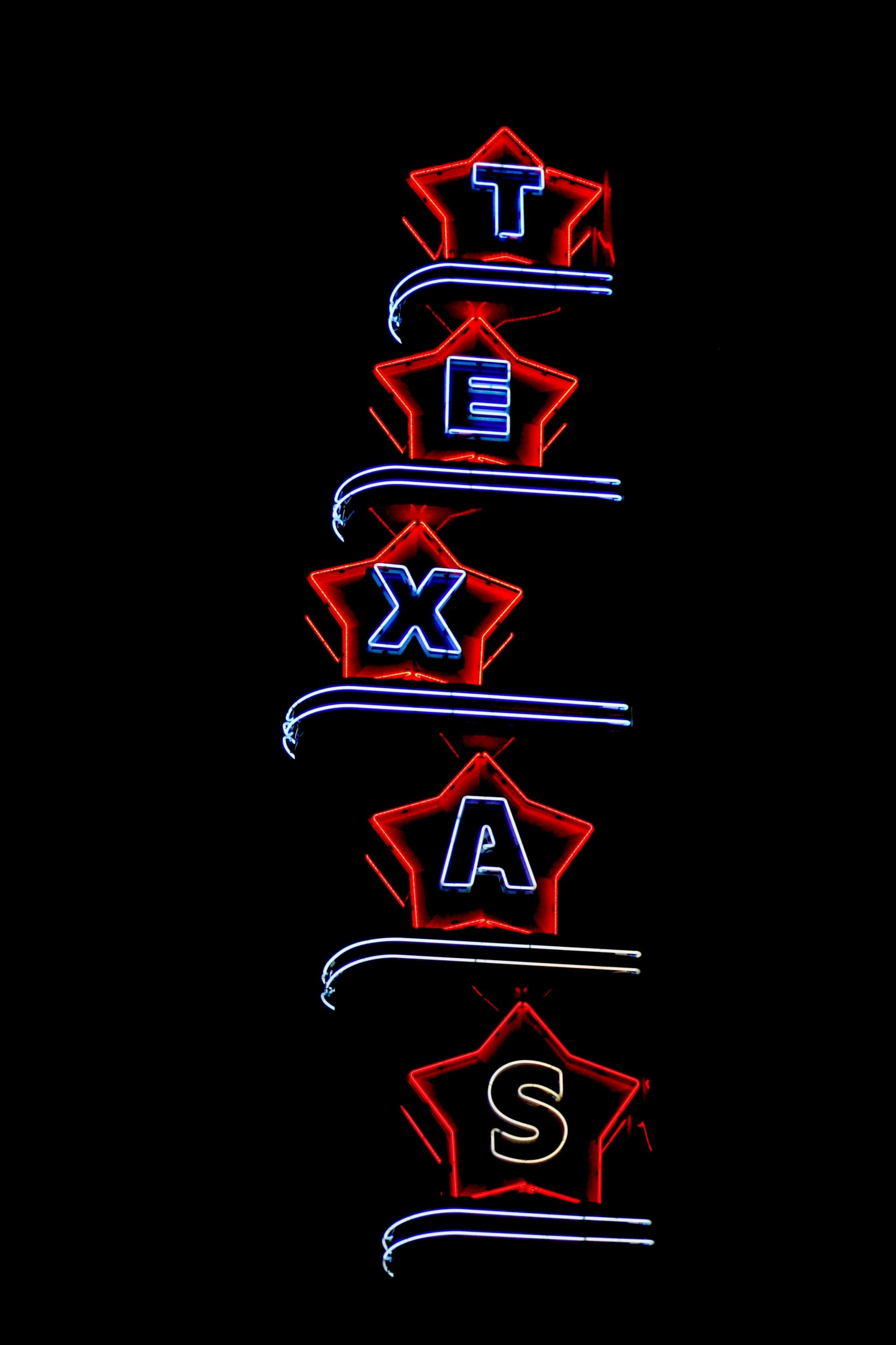 A neon sign of Texas during nighttime.