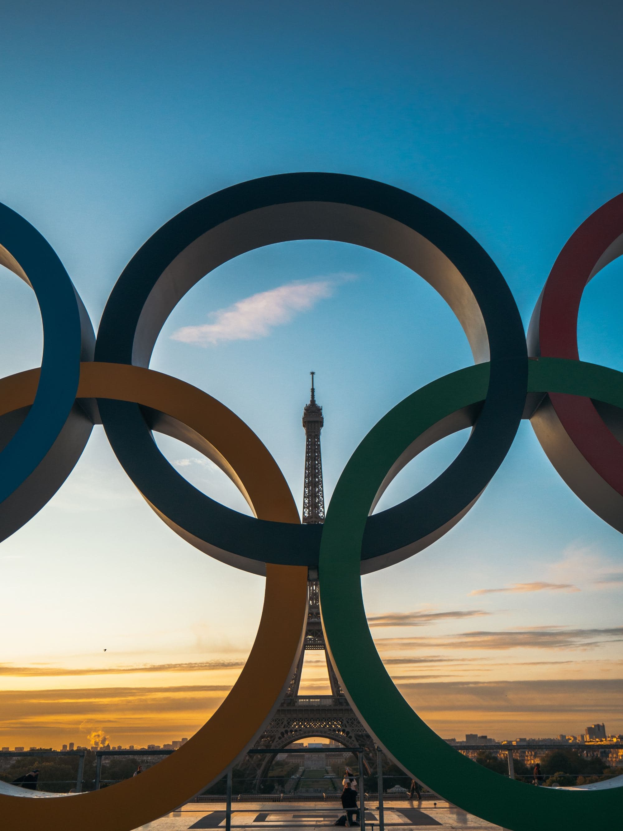 Olympic sign in front of Eiffel Tower.