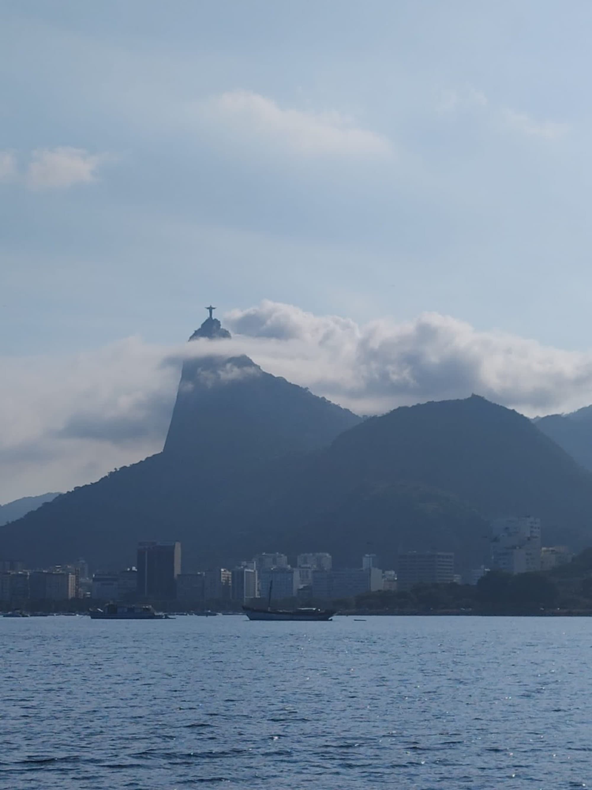 An aerial view of the sea and the city with mountains from afar.