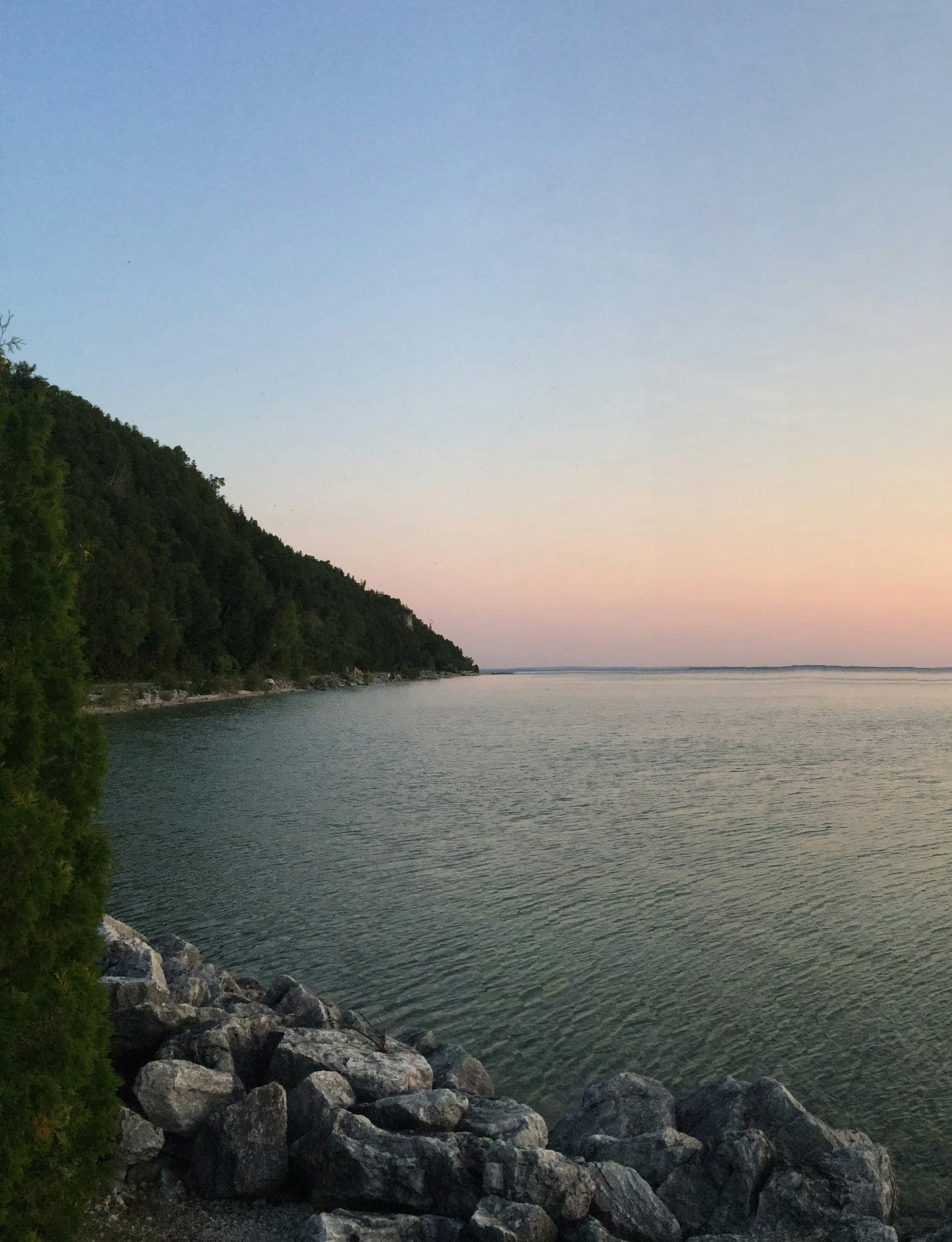 Sunset view of cliffs and water.