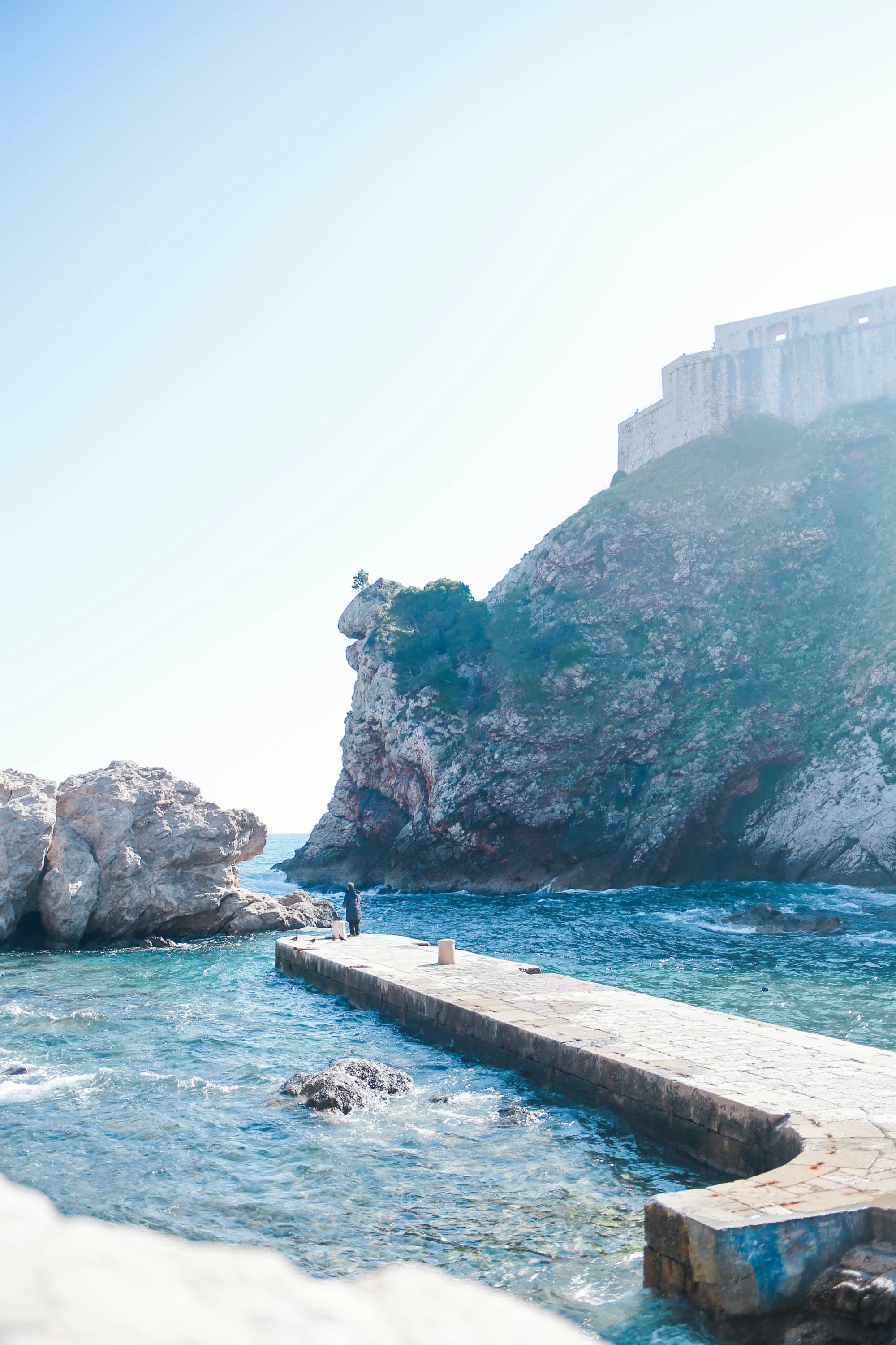 A long harbor in the water between cliffs during the daytime