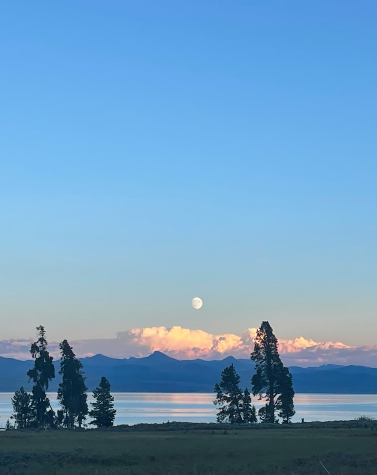 A body of water with mountains in the distance during the daytime