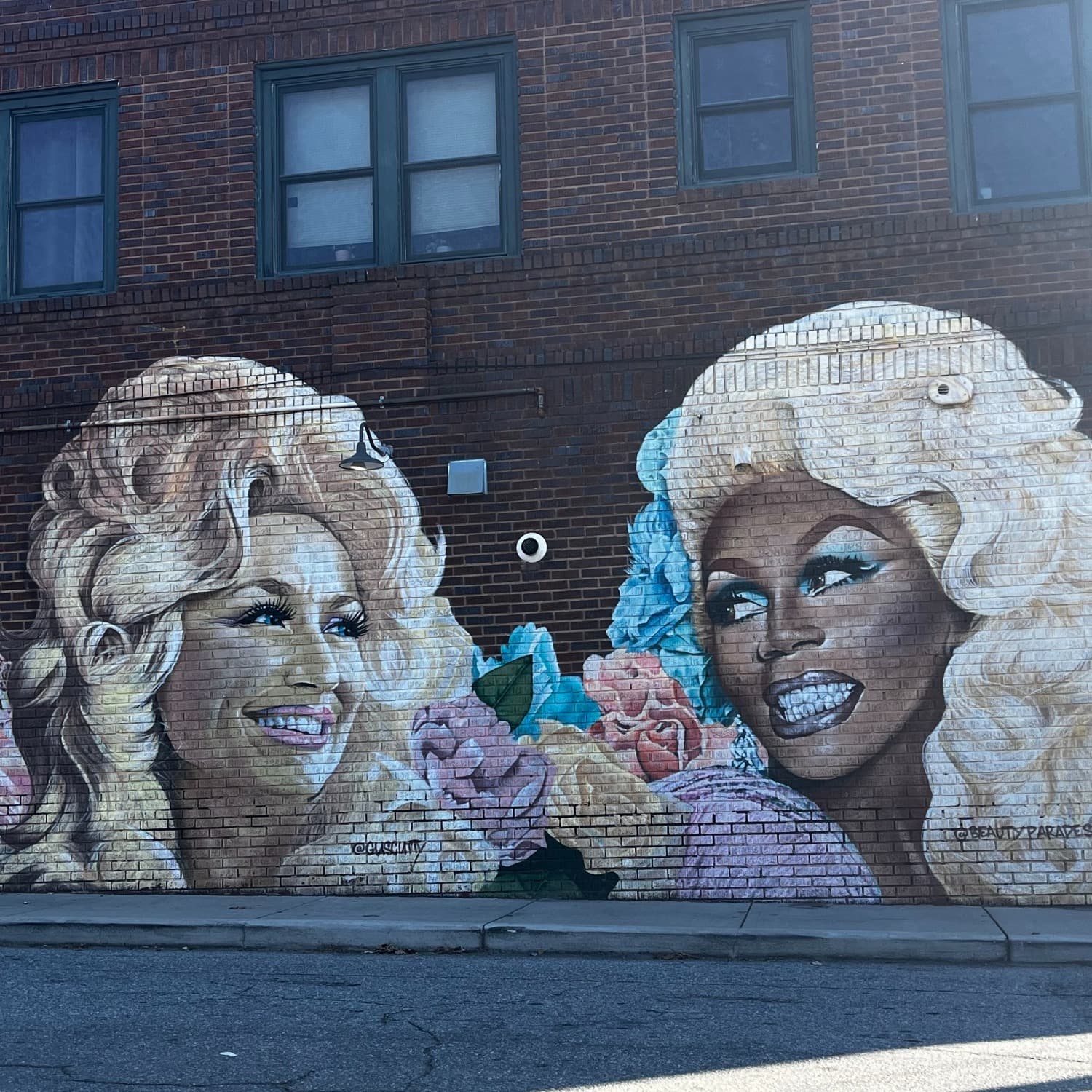Paintings of two women on wall.
