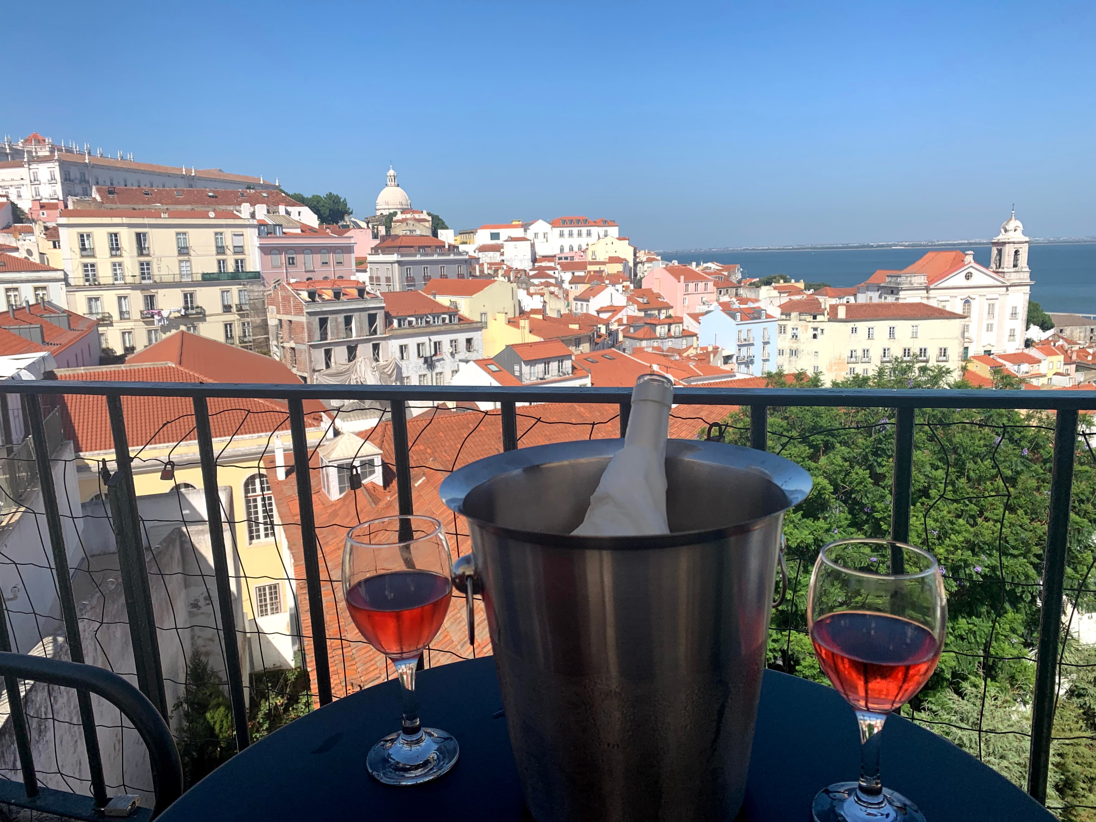 A nice glass of wine and the views of Lisbon in the distance.