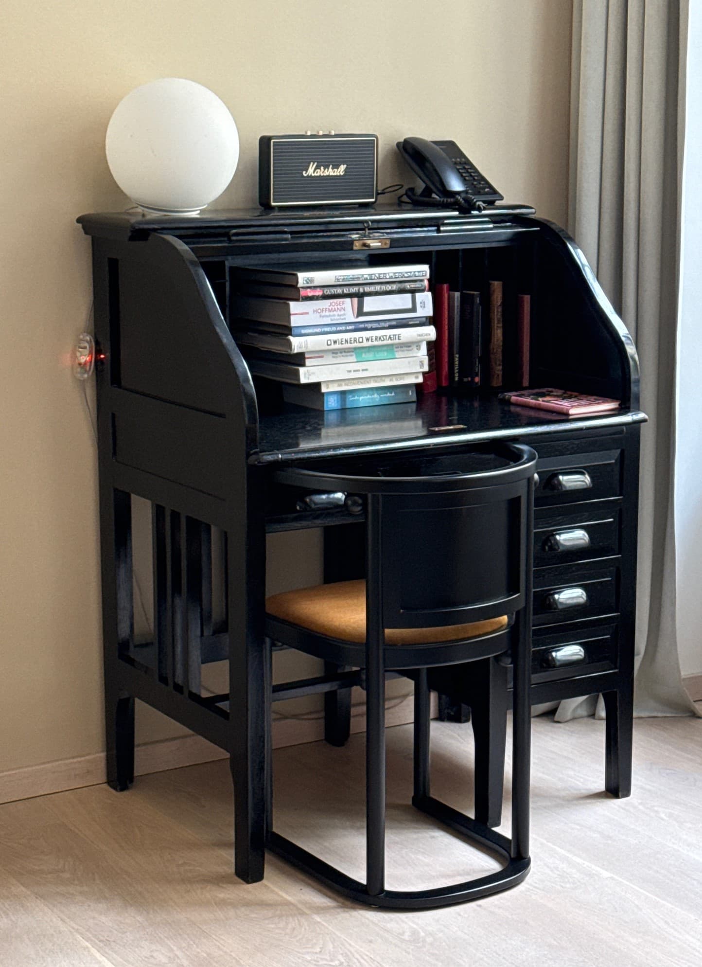 A black desk in a hotel room