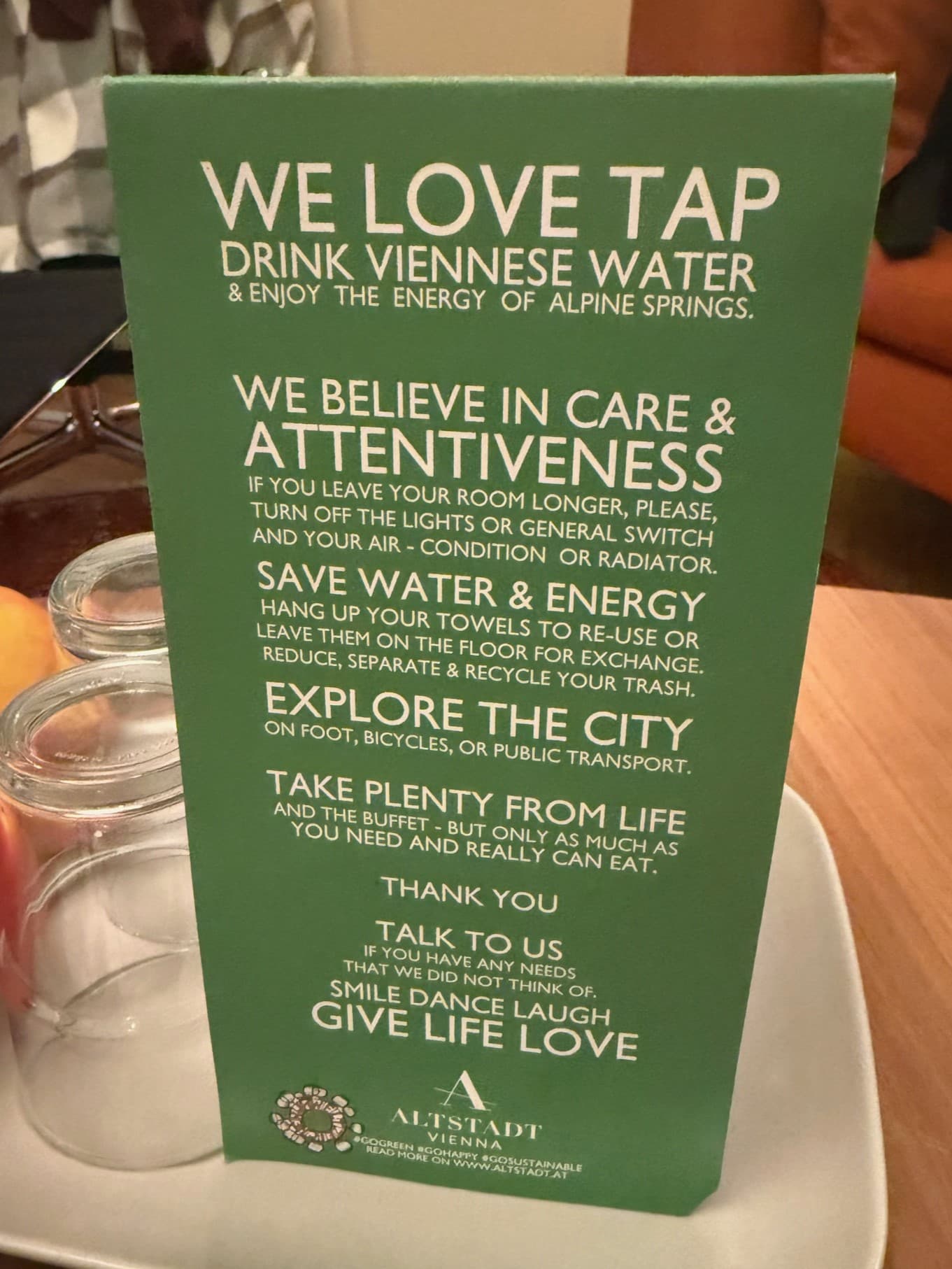 A green menu standing up on a table
