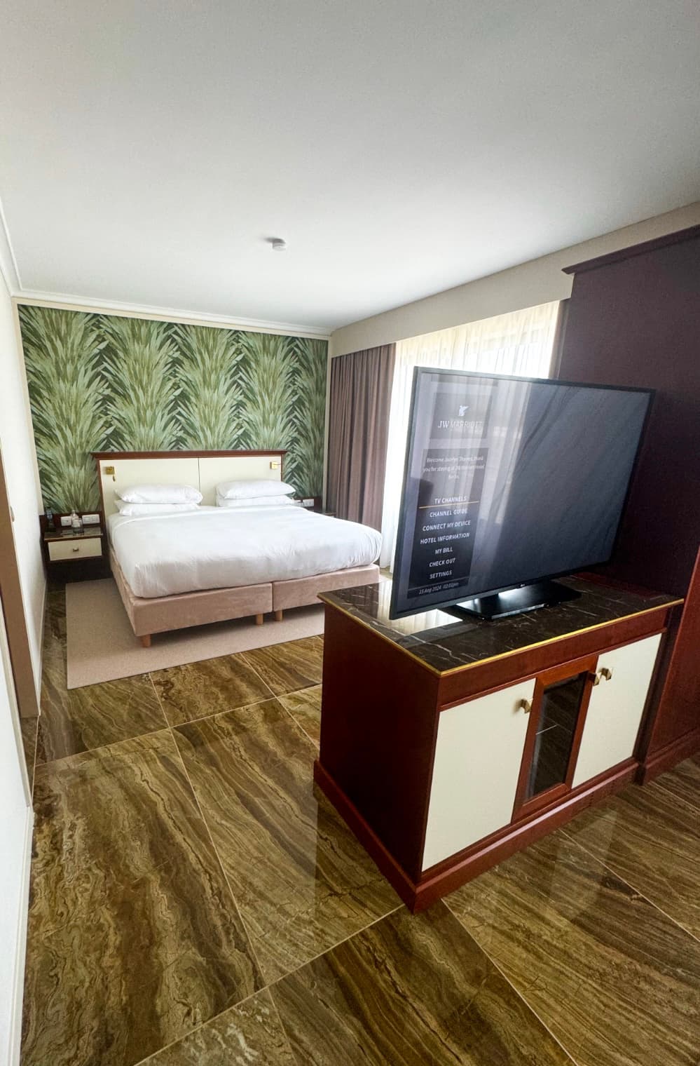 A bed and television set in a hotel room