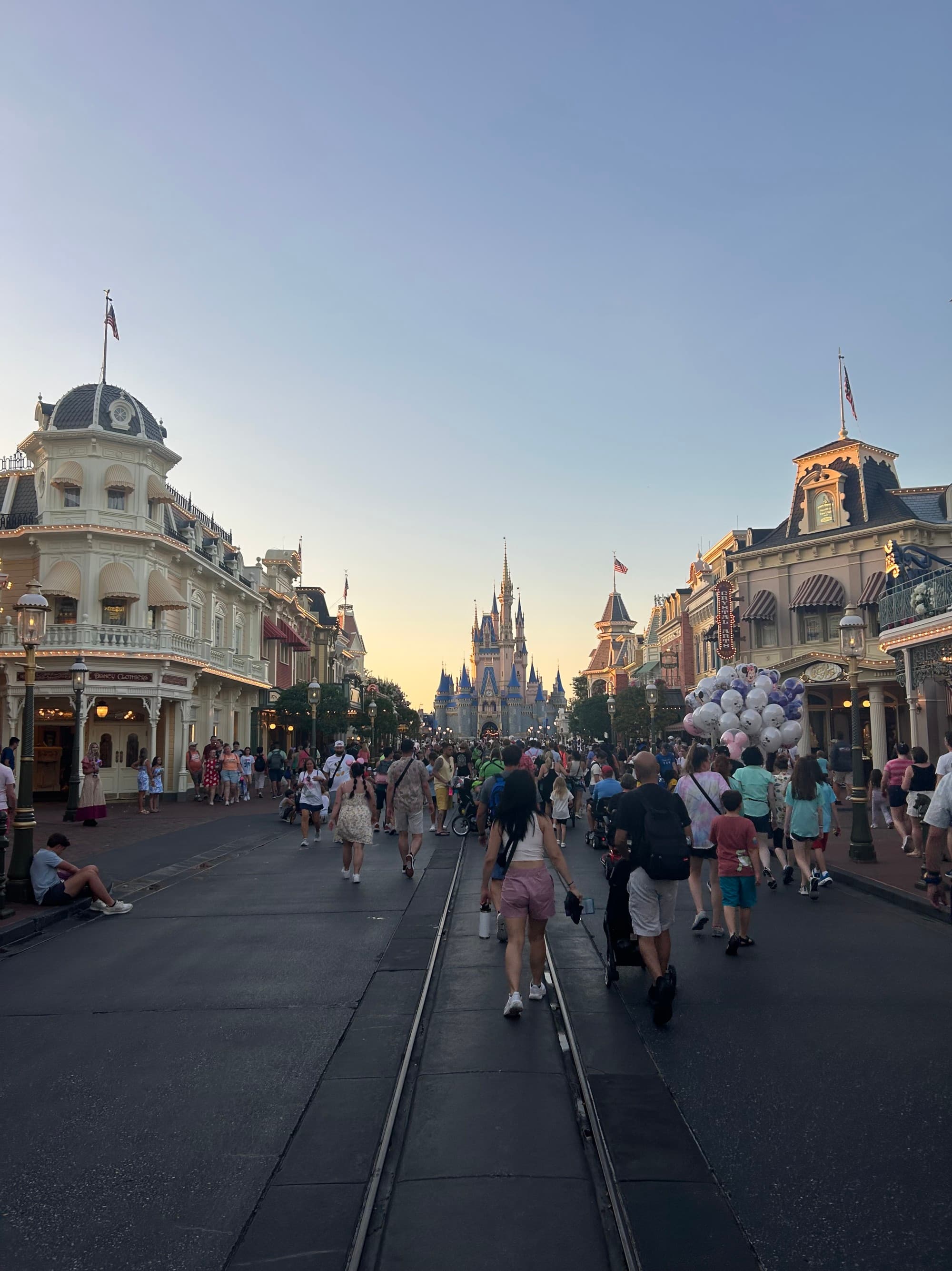 A view of Main Street and Cinderella's Castle at dusk.