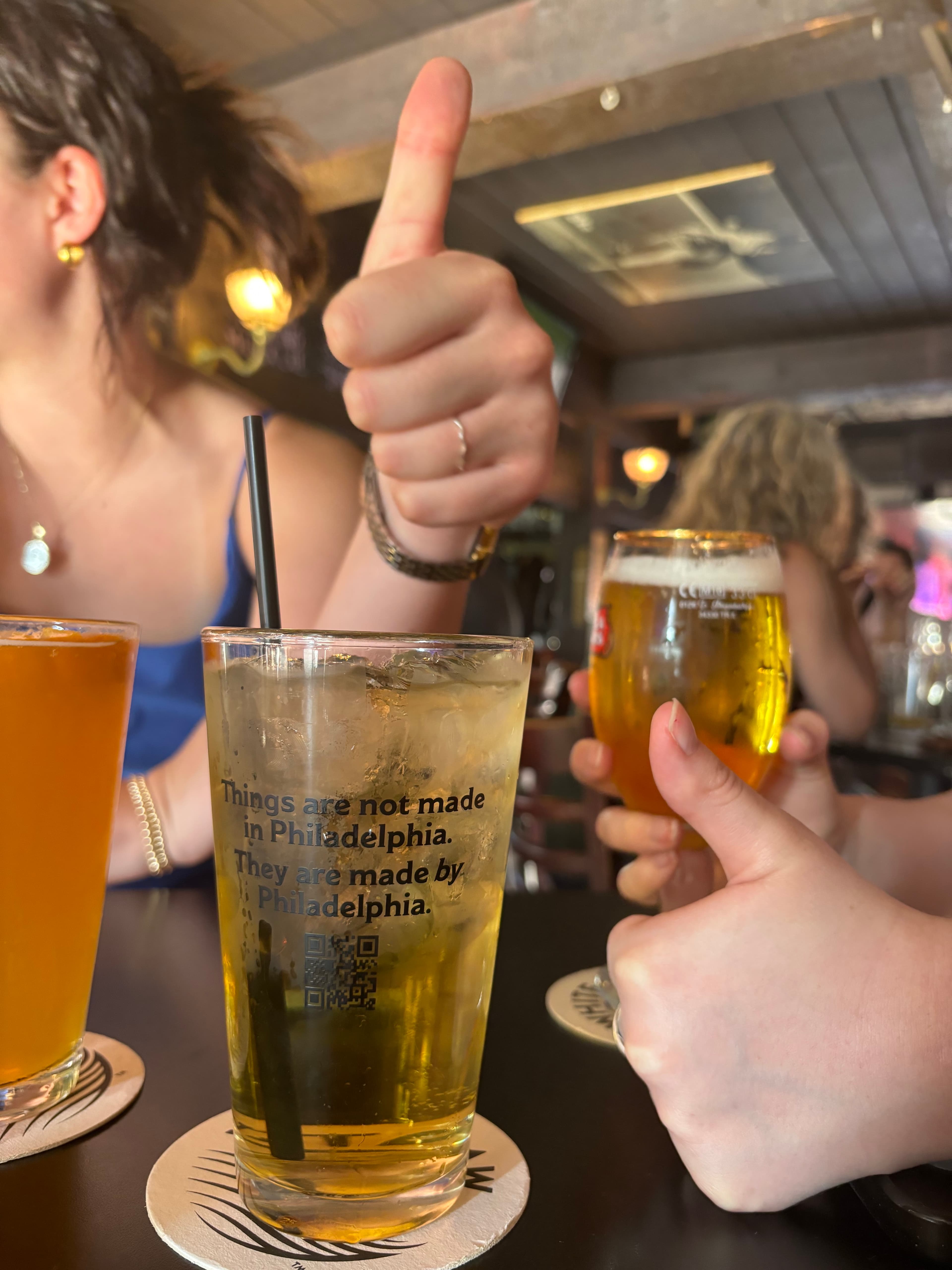 Pint glasses on a table, one of which says "Things are not made in Philadelphia, they are made by Philadelphia."
