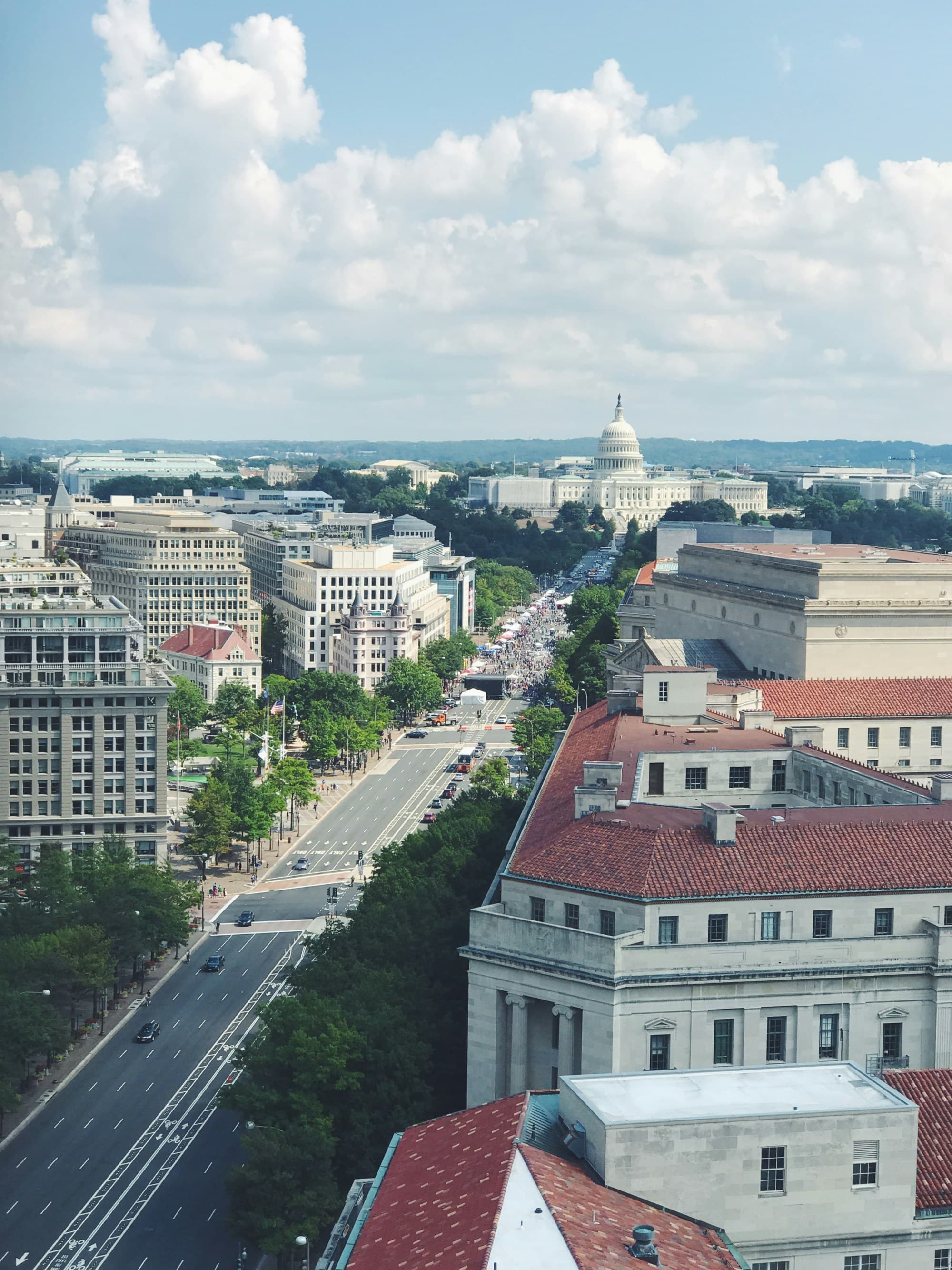 A high-angle cityscape view with a busy, wide avenue leading to a domed building in Washington DC.