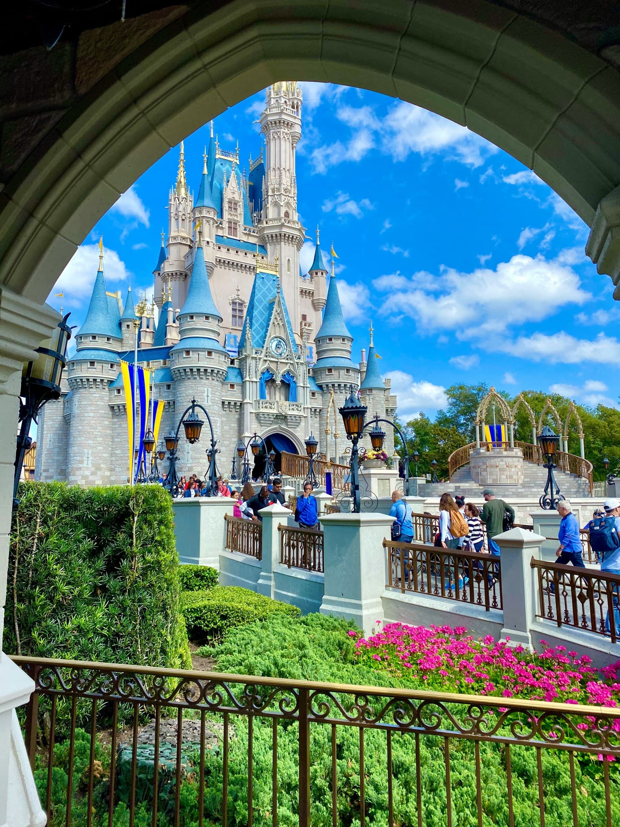 A picture of the blue-and-white Cinderella castle through an arch.