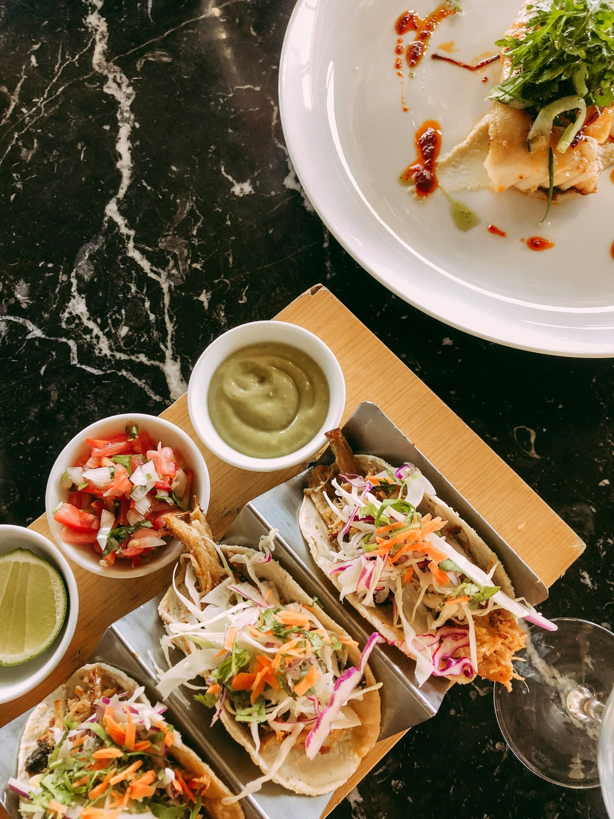 Overhead photo of plated food on a black table