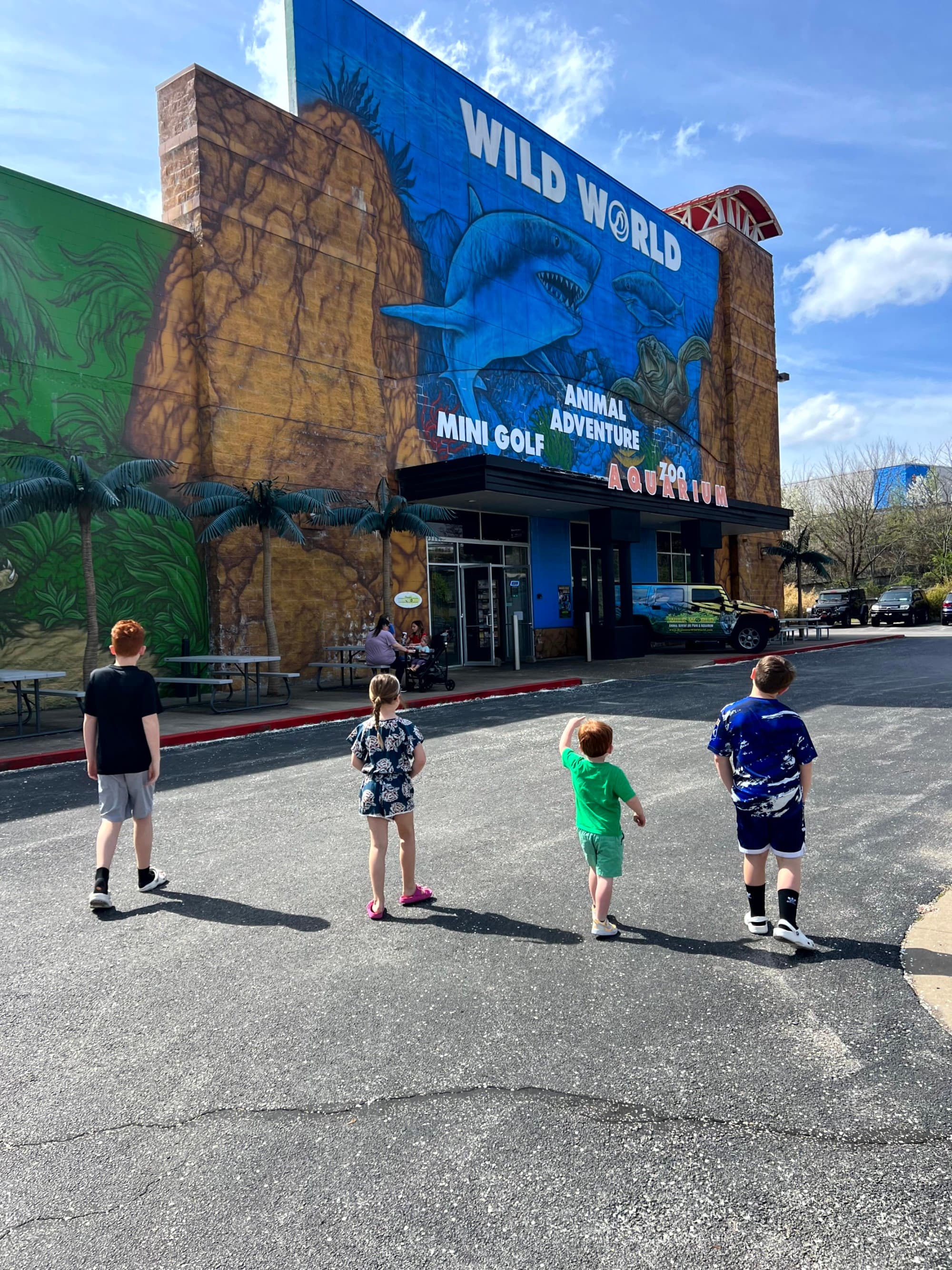 A cheerful family embarks on an adventure at Wild Island, where fun and excitement await under the sunny sky.