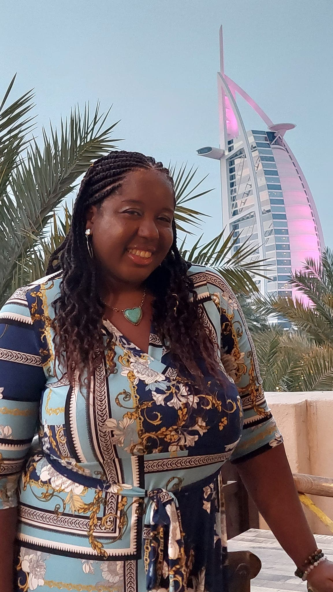 Guide posing for a photo with a tower in the background