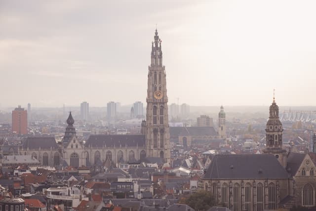 A view of Antwerp's skyline and architecture on a foggy day.