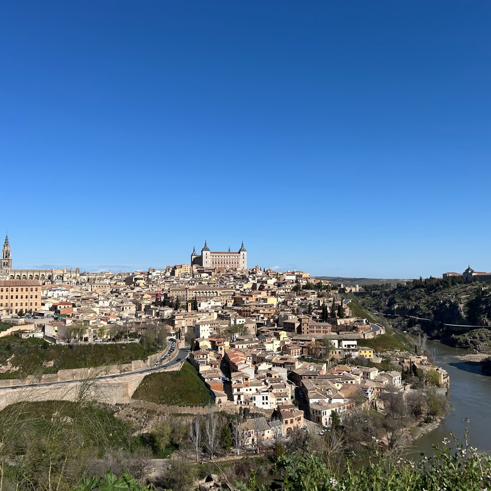 Aerial view of city besides body of water.