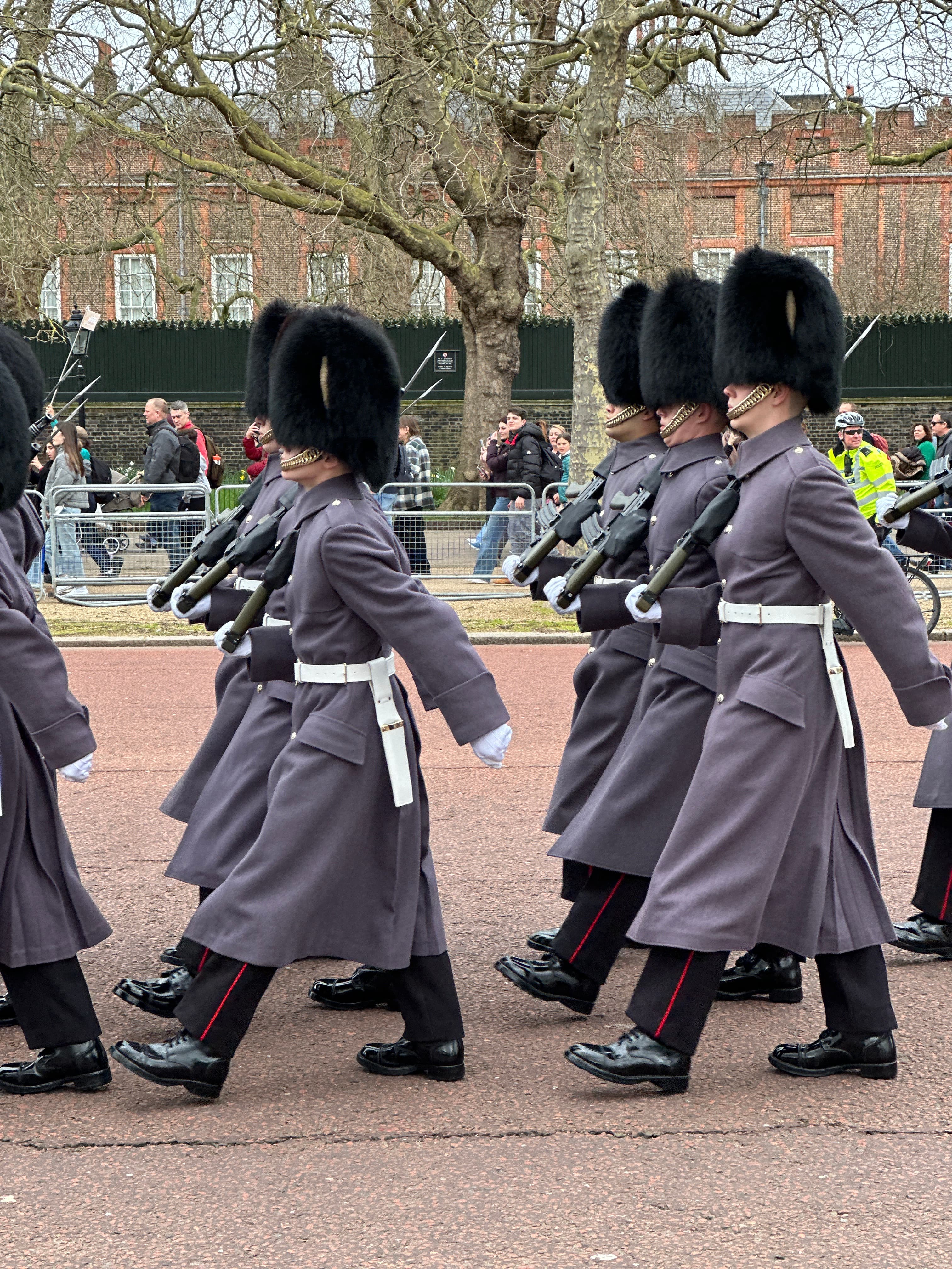 Changing of the Guard at Buckingham Palace in London with the guards dressed in traditional outfits and hats