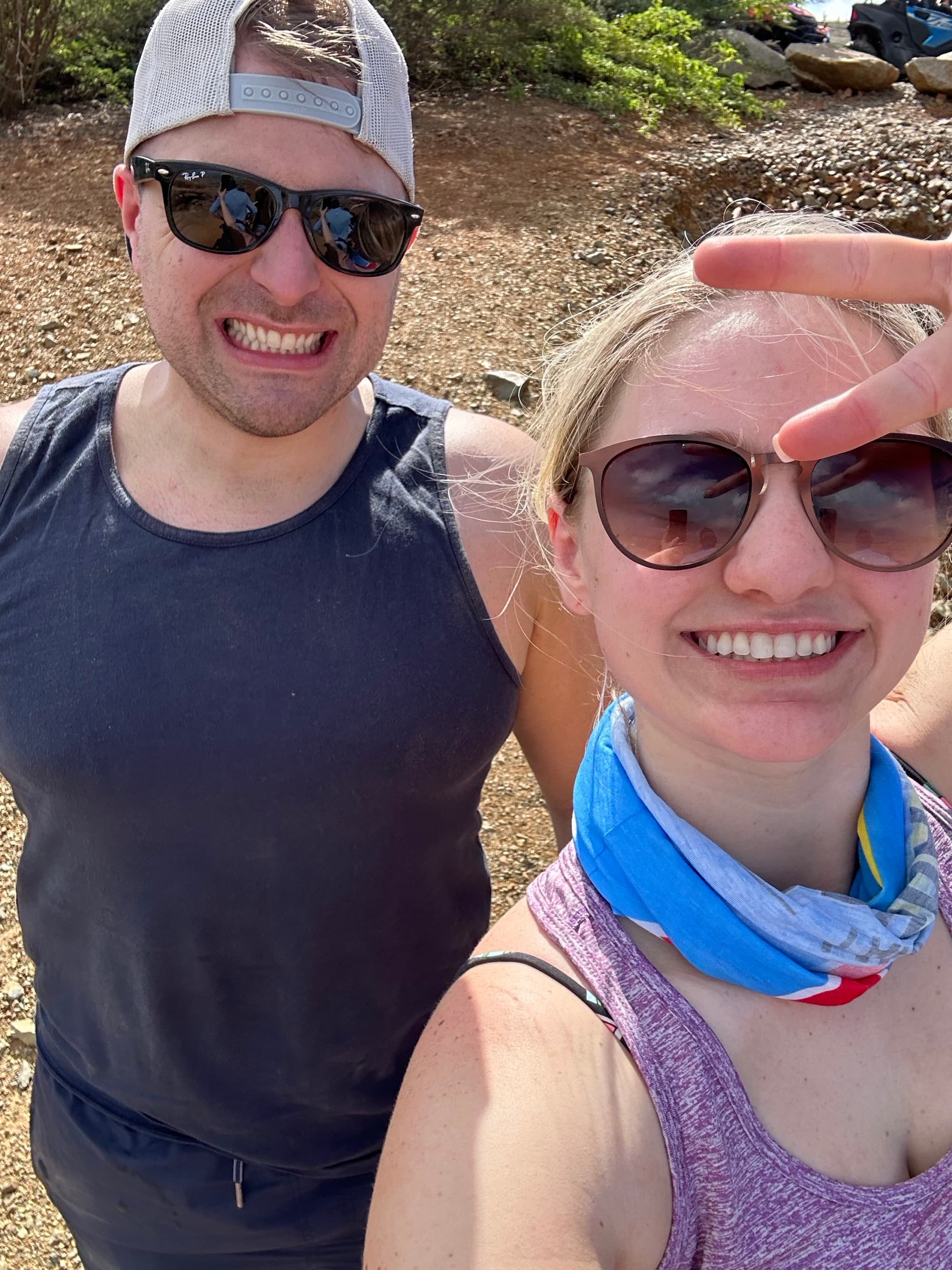 A couple outdoors posing for a selfie.