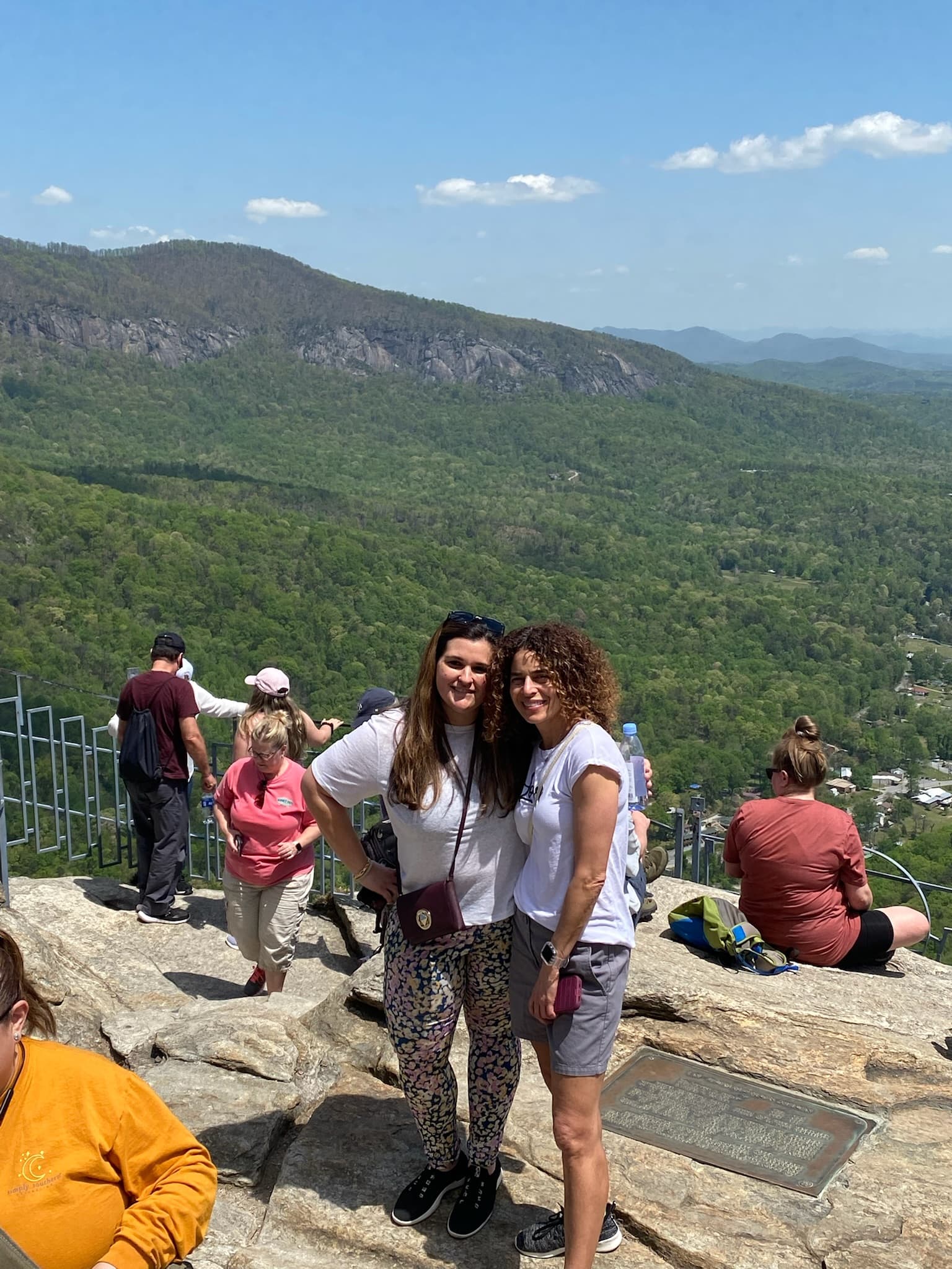 An aerial view of people standing on a cliff.