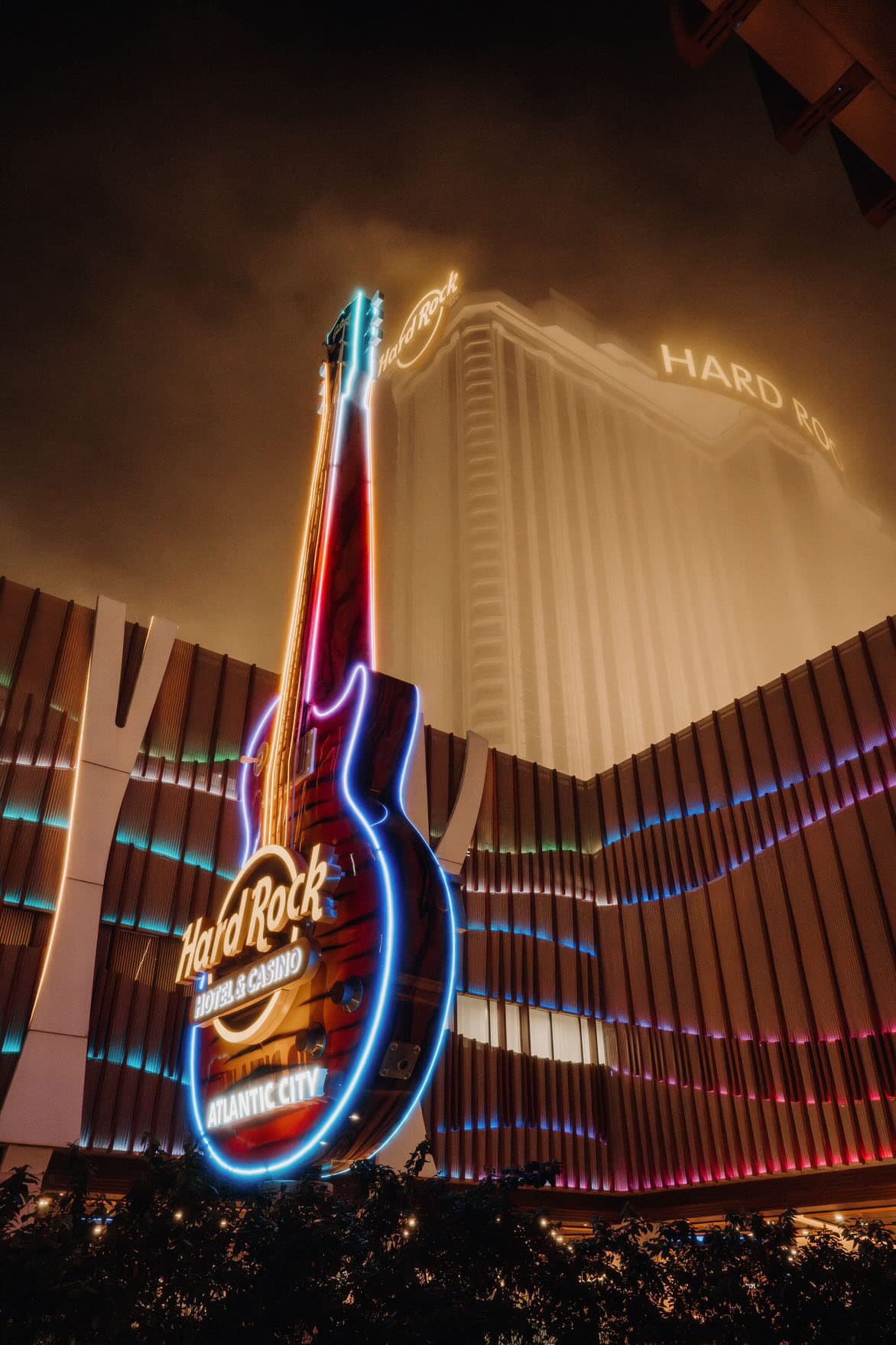 A view of the Hard Rock Café neon guitar sign outside.
