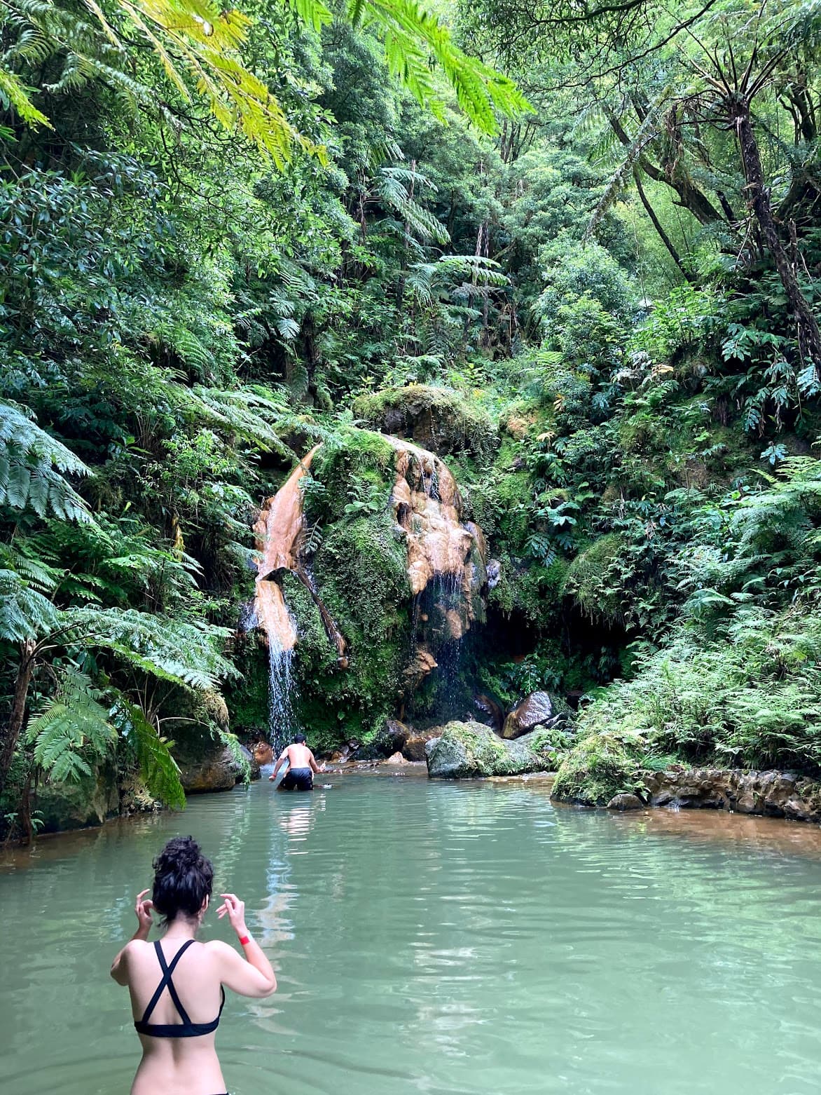 Tourists at a waterfall in São Miguel Island in Azores, Portugal