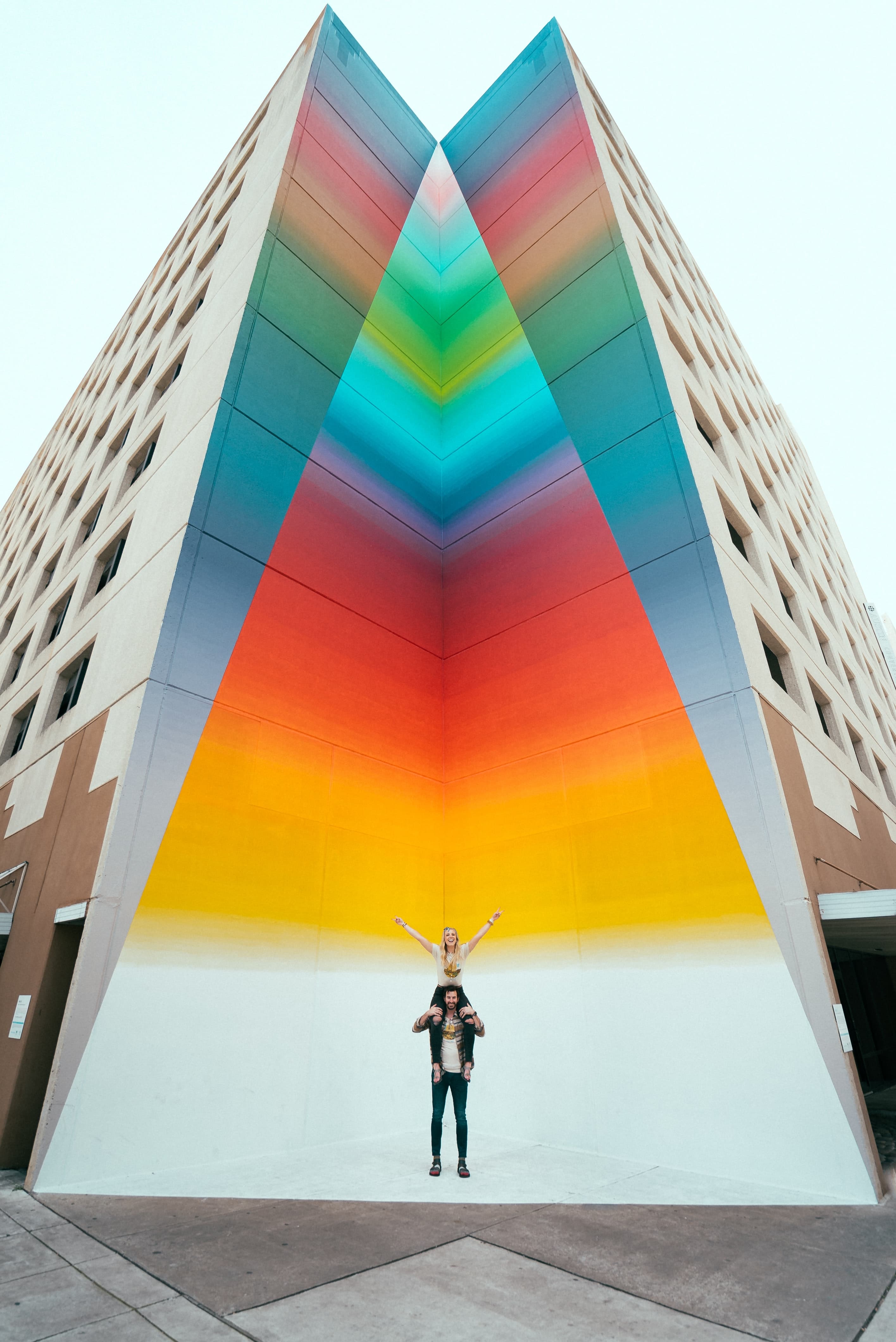 Couple standing in front of street art in Texas.