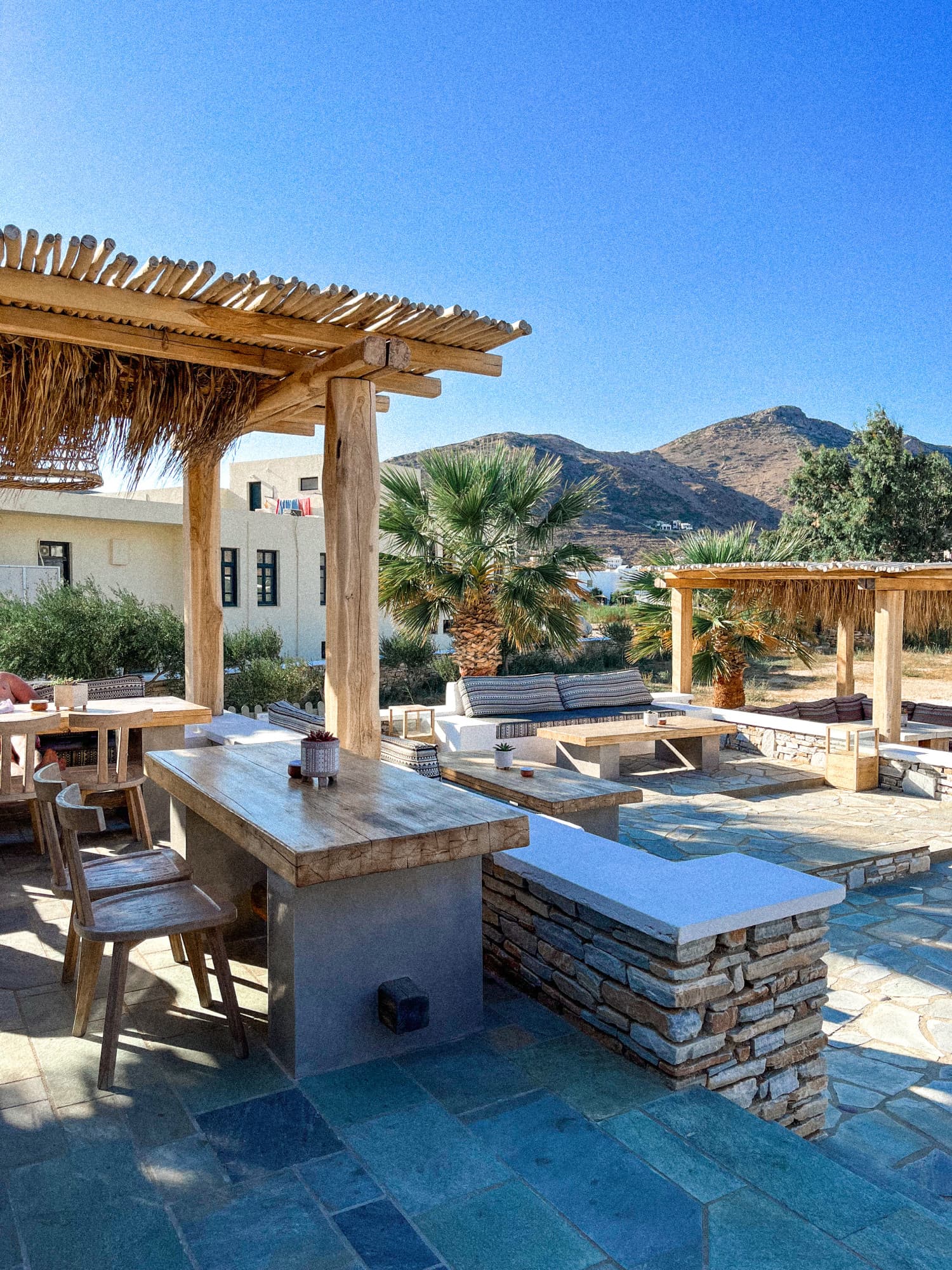 Outdoor seating area in front of Ios island at Yialos Hotel in Greece.