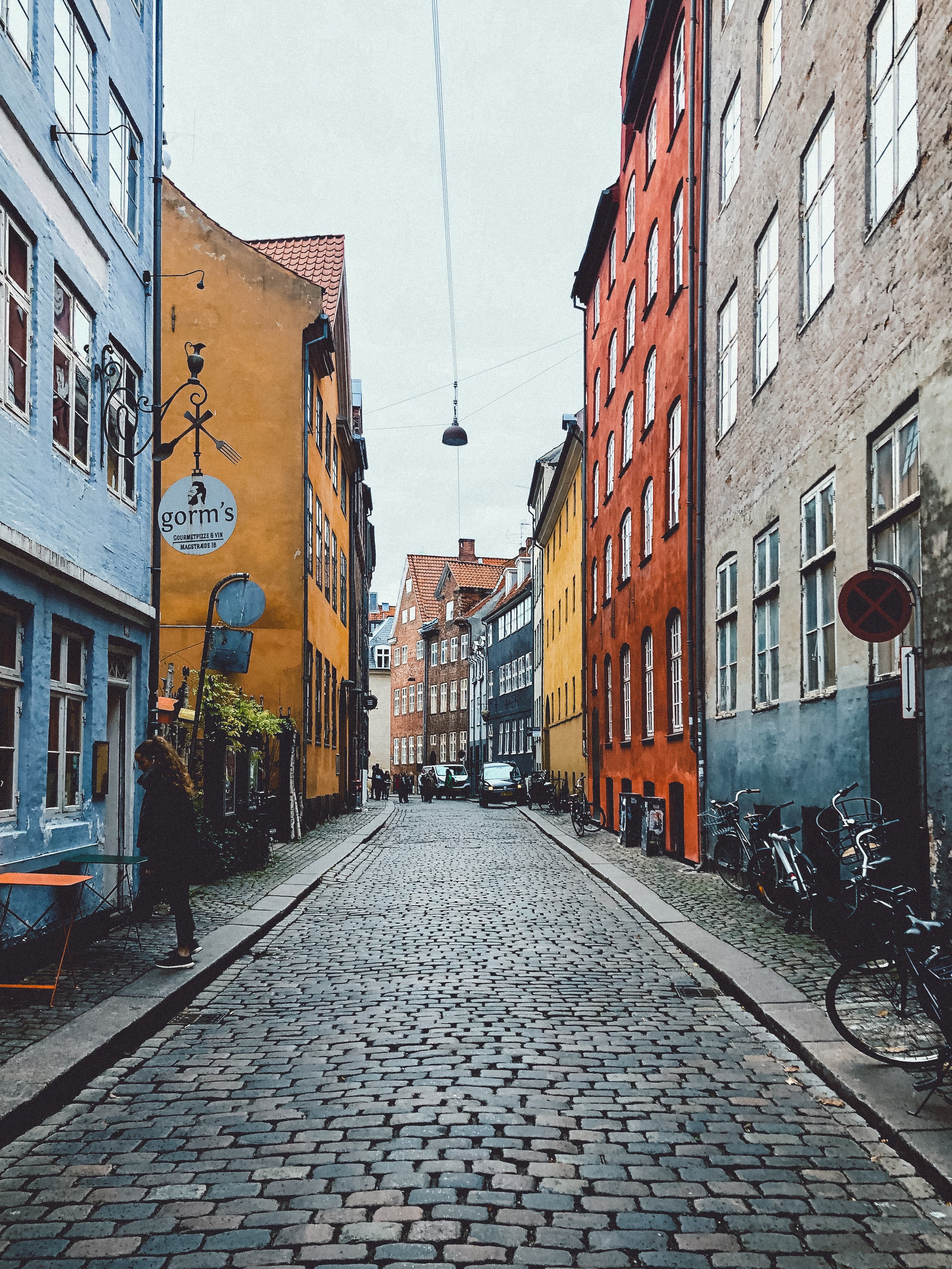 Cobblestone street lined with colorful buildings during daytime