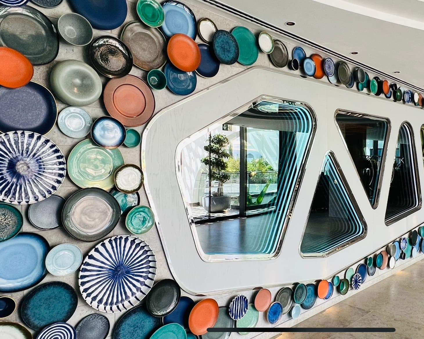 A wall decorated with colorful ceramic plates.