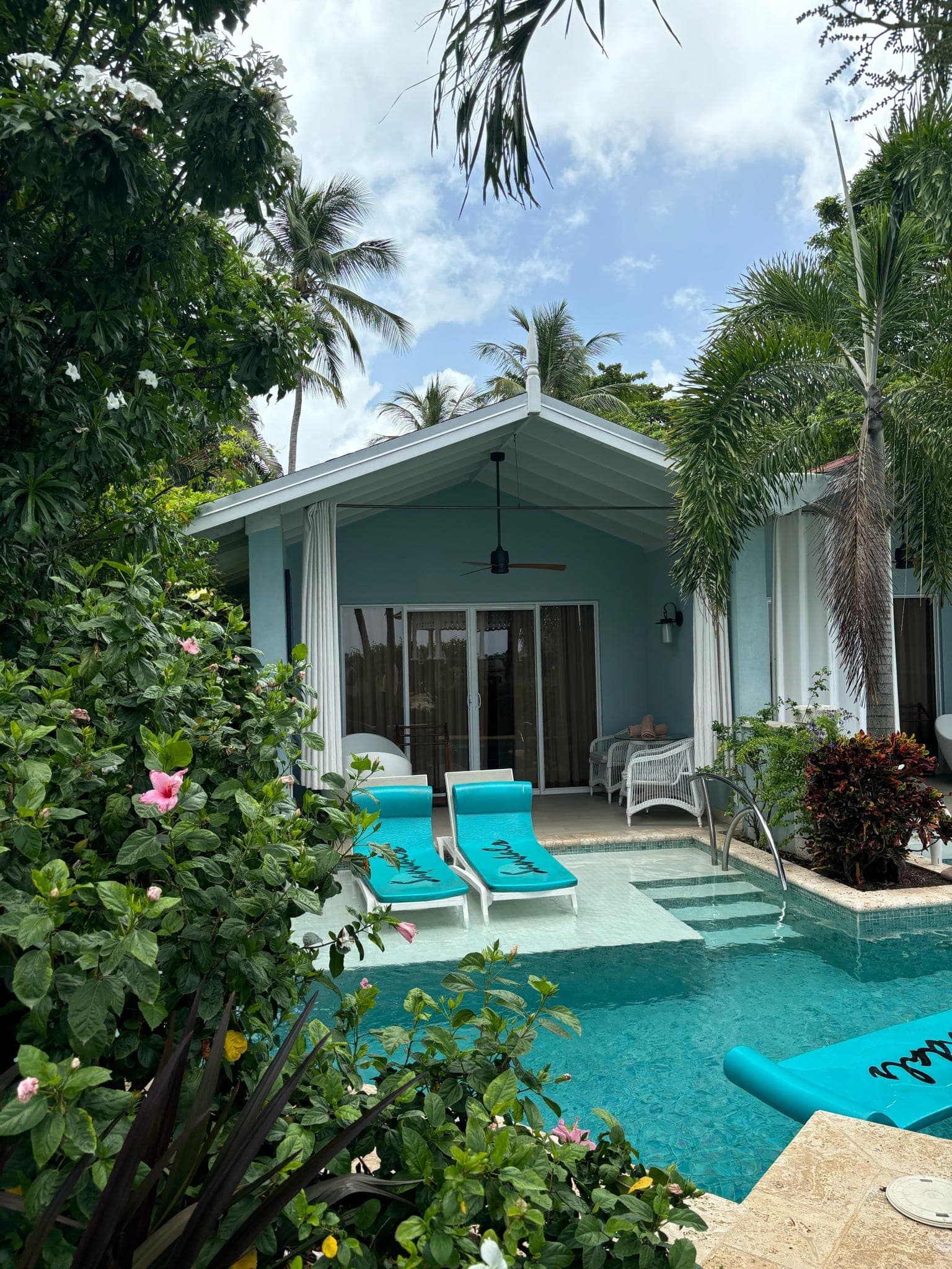 A swim up pool area in front of a hotel suite