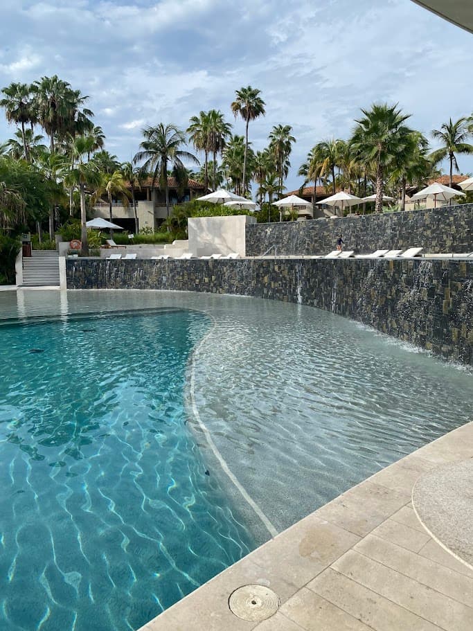 A plunge pool with a waterfall feature during the daytime
