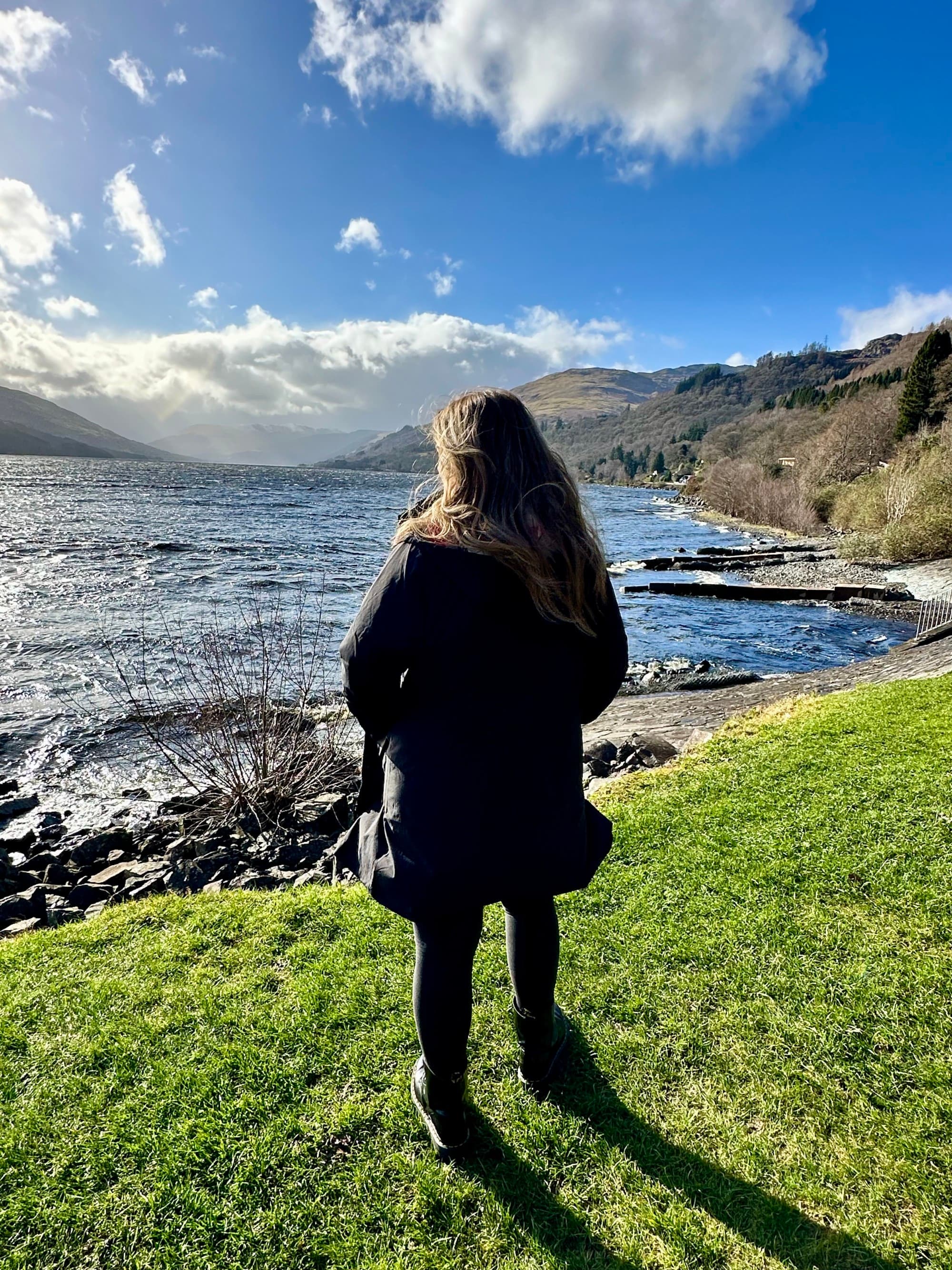 Advisor standing on the highlands overlooking the ocean and cliffs.