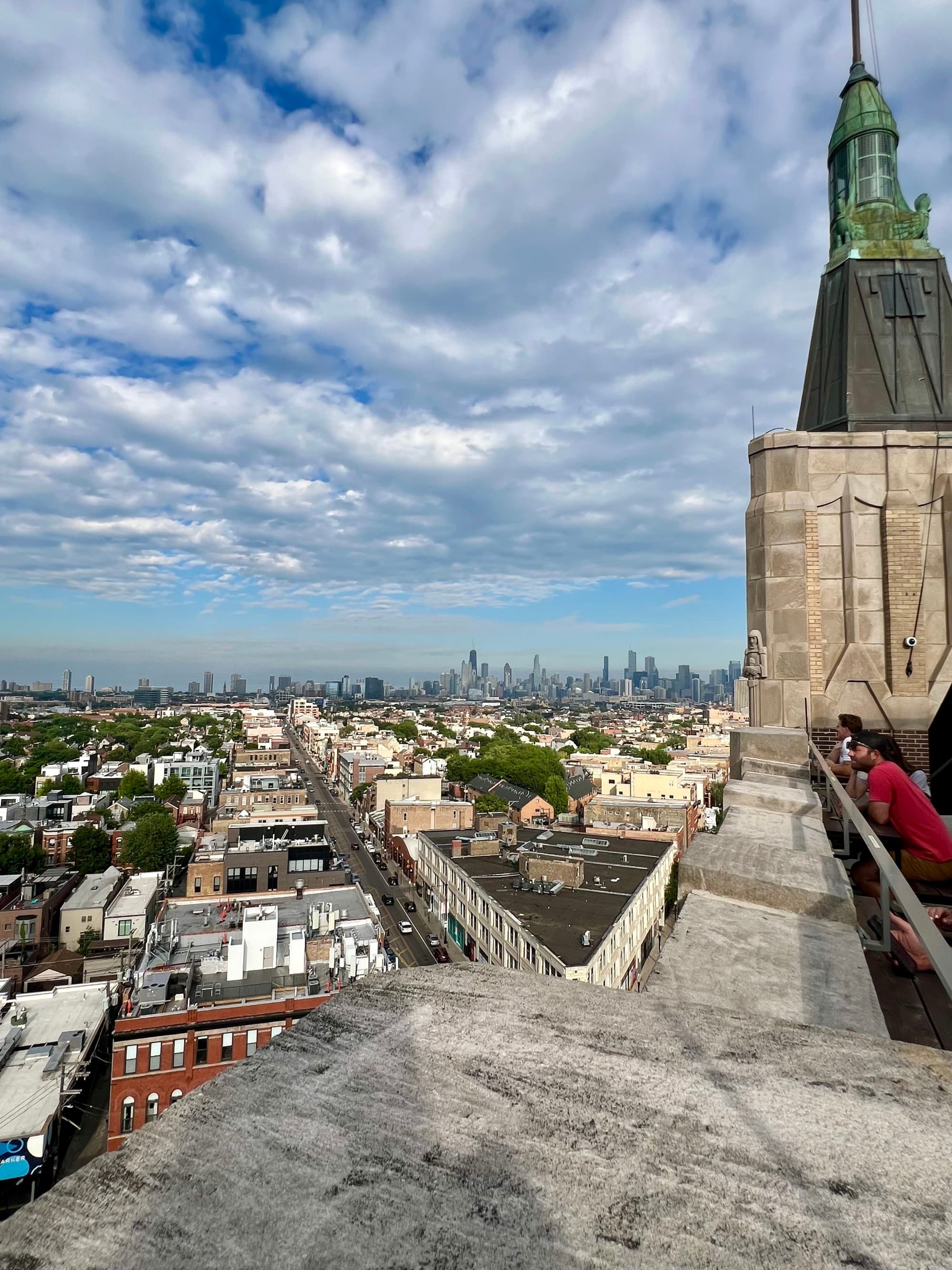 Skyline view of Chicago with Art Deco rooftop visible in the foreground.