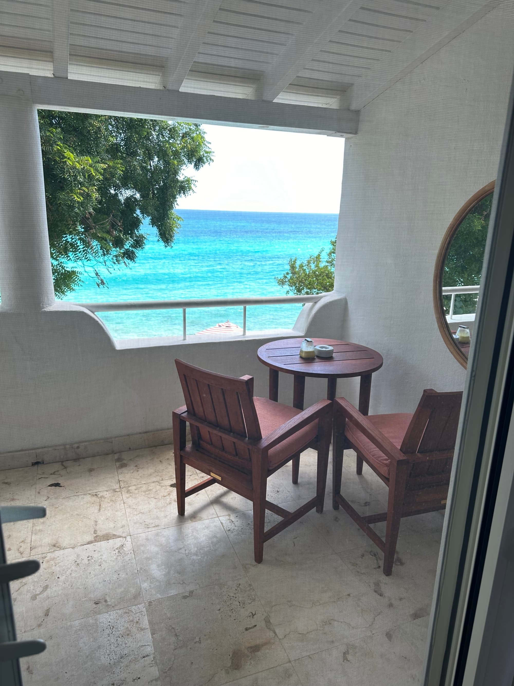 View of the sea from the patio deck as sun reflects of the crystal-clear waters.