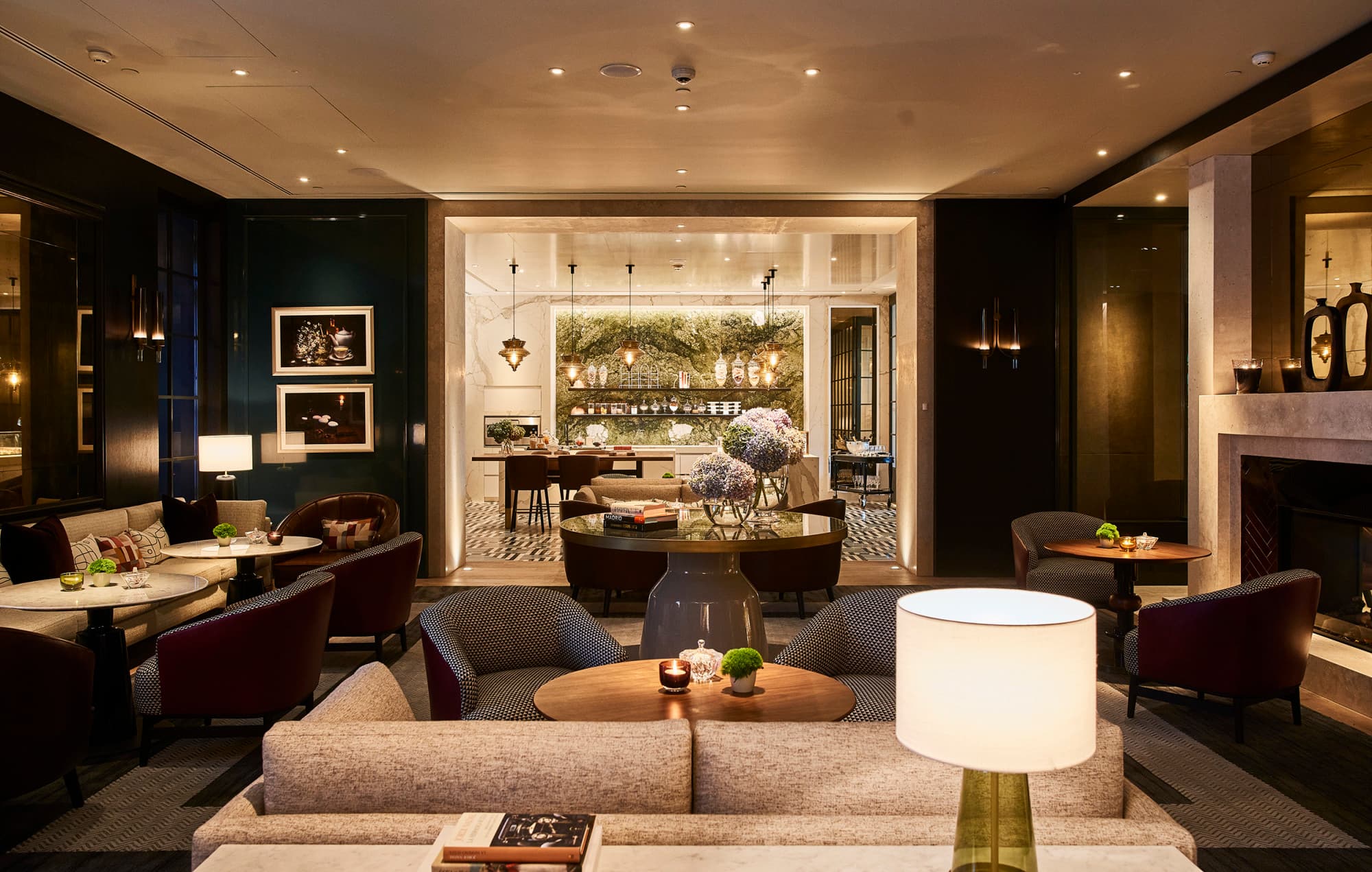 a handsome hotel lobby filled with fancy furniture and dim lighting