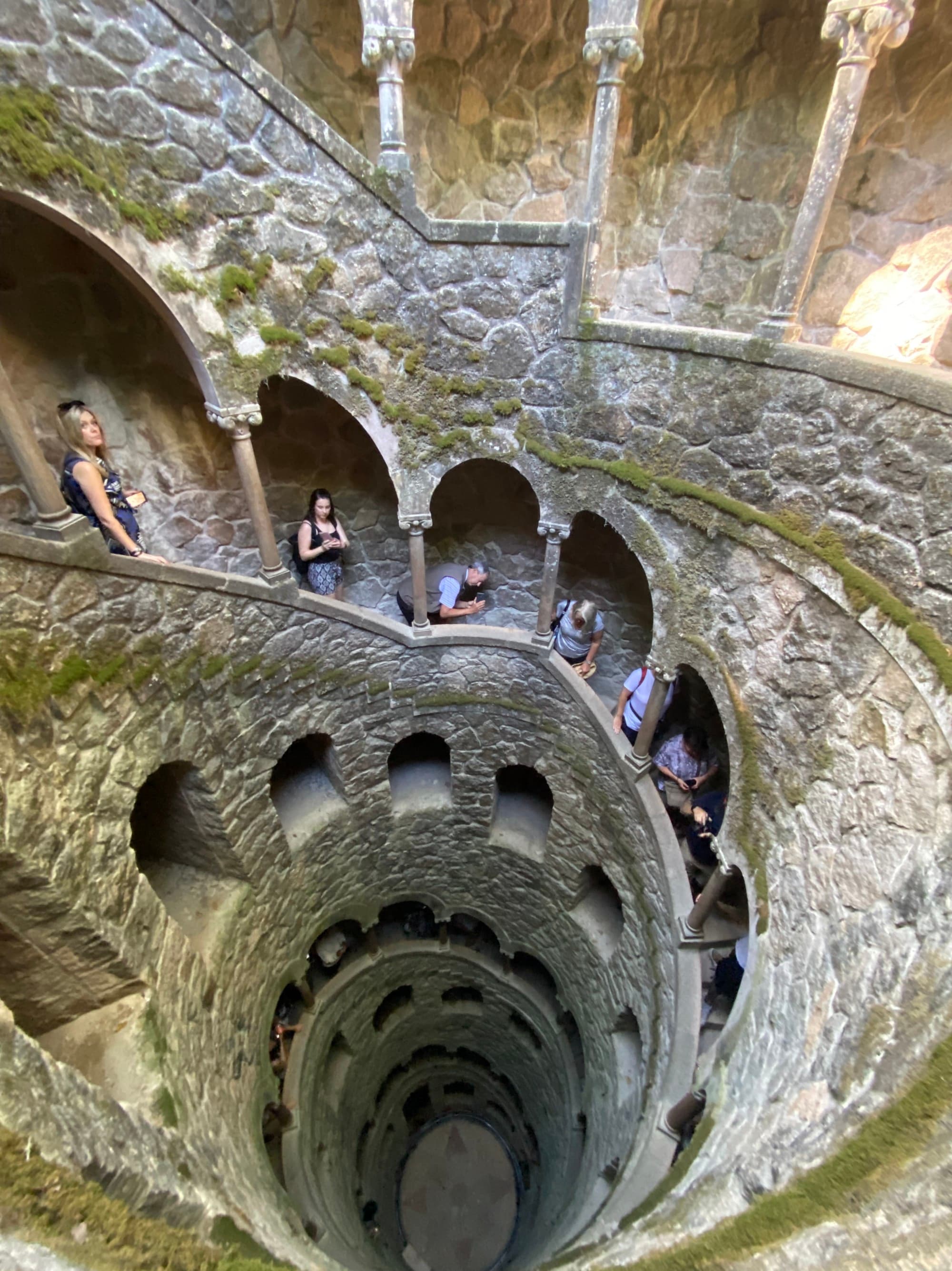 The Initiation Well staircase winds upward and is lined with tourists trying to reach the top.