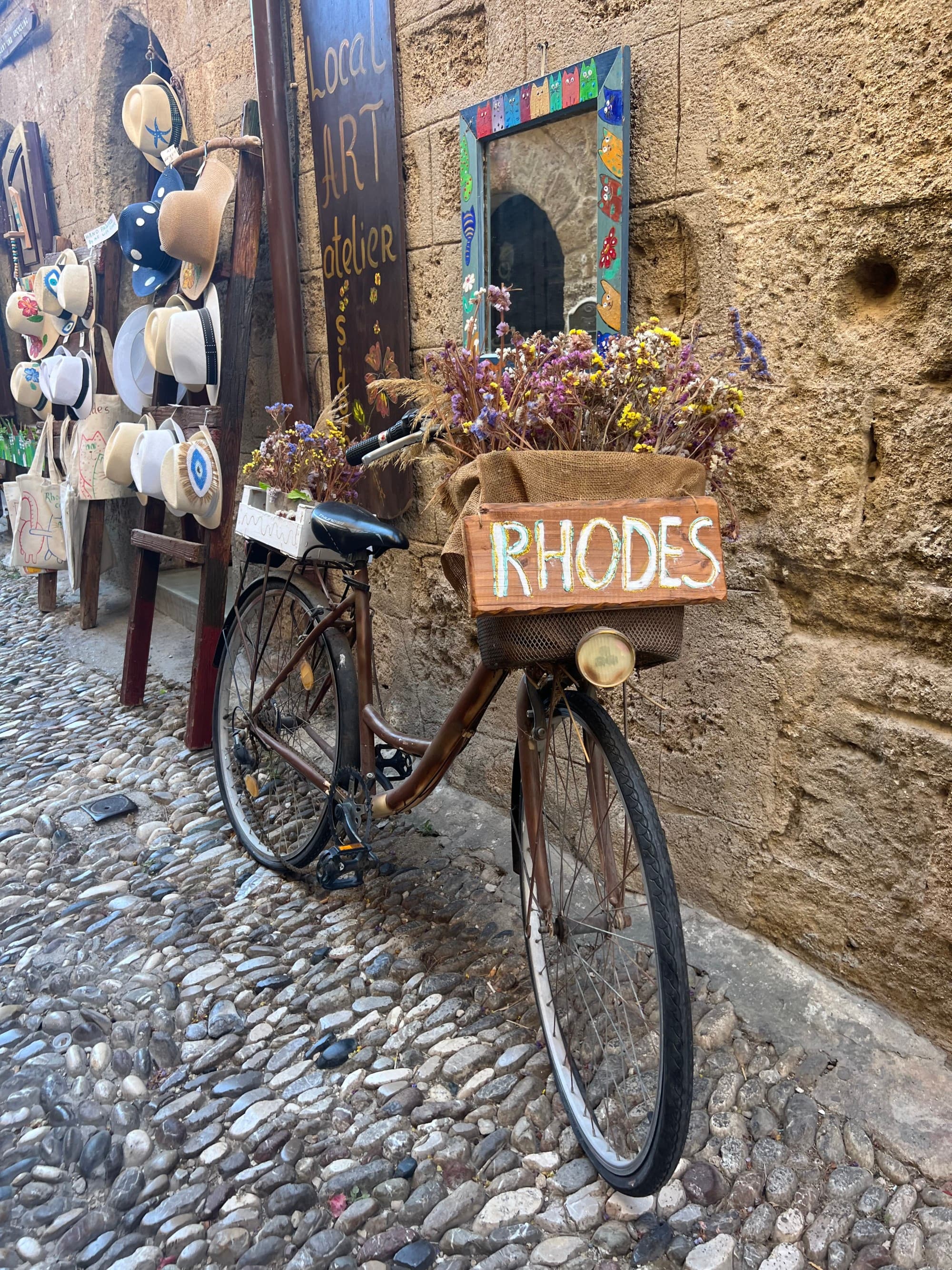 Bicycle with a cardboard sign that says "Rhodes."