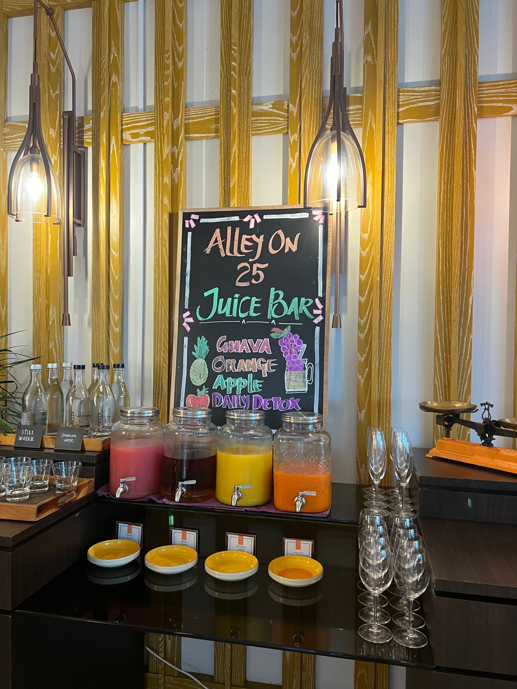 Breakfast juice bar with multicolored juice options.