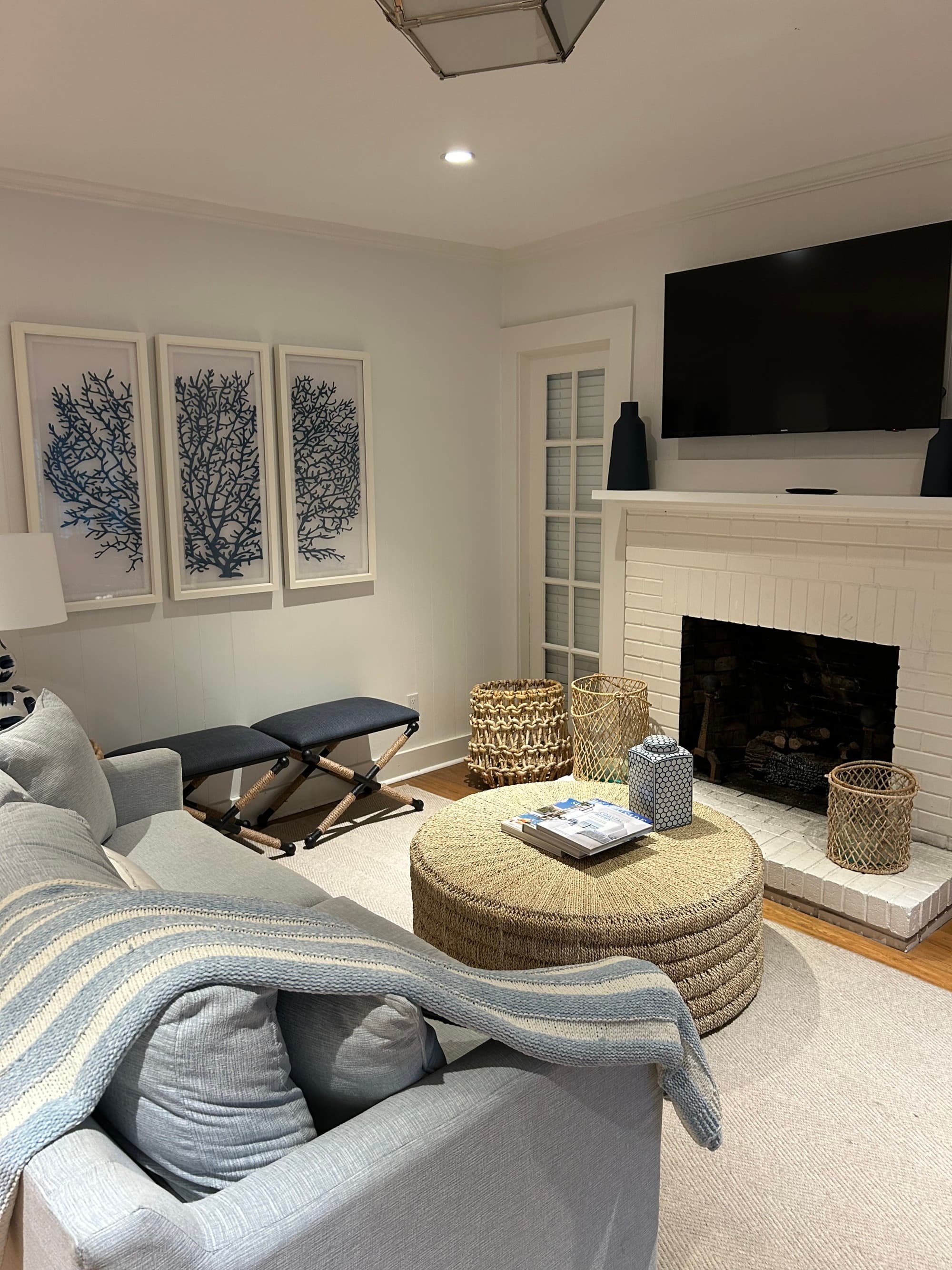En-suite living with a light blue couch and a fireplace.