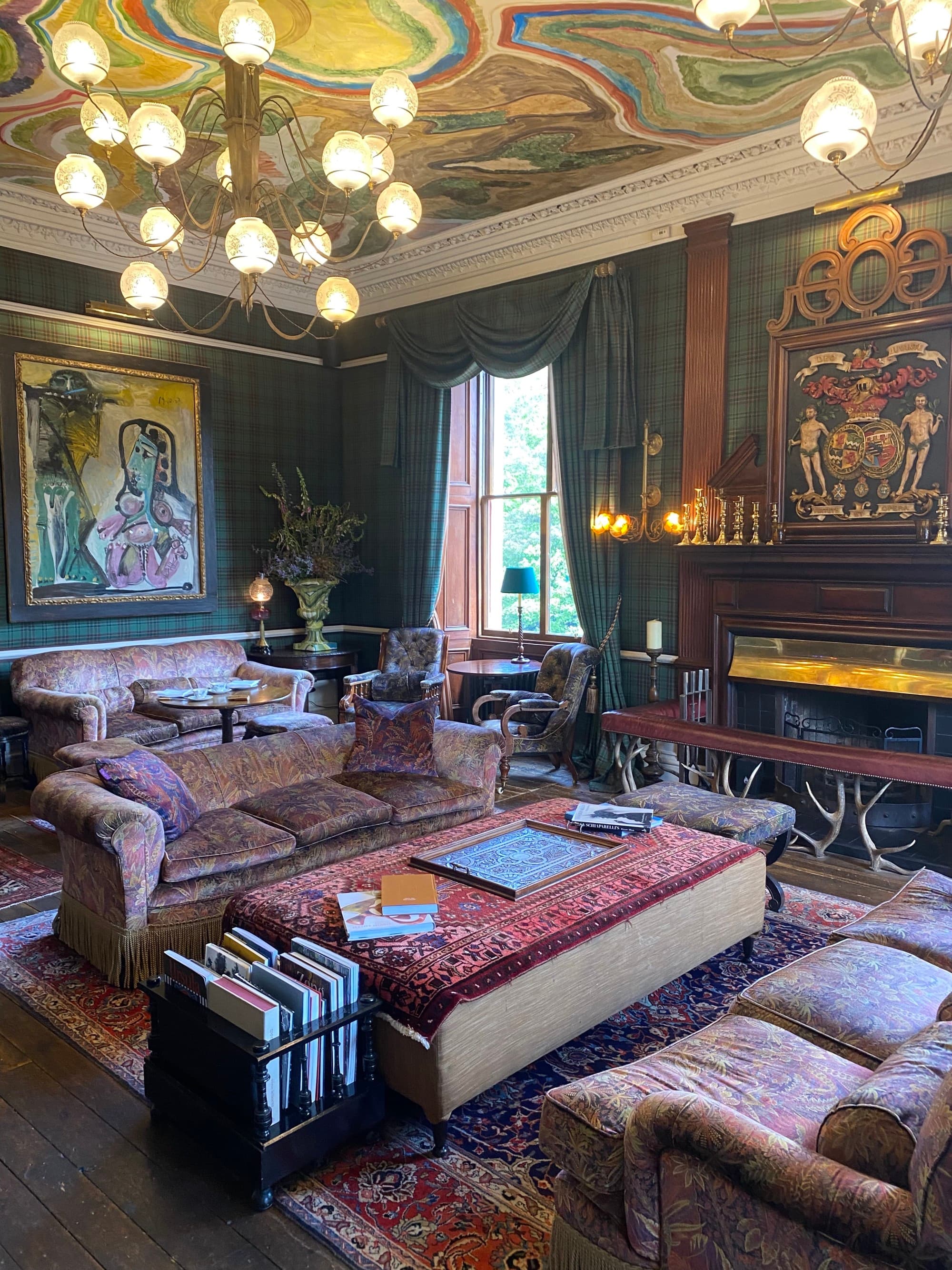 Lounge with leather couches and stacks of books.