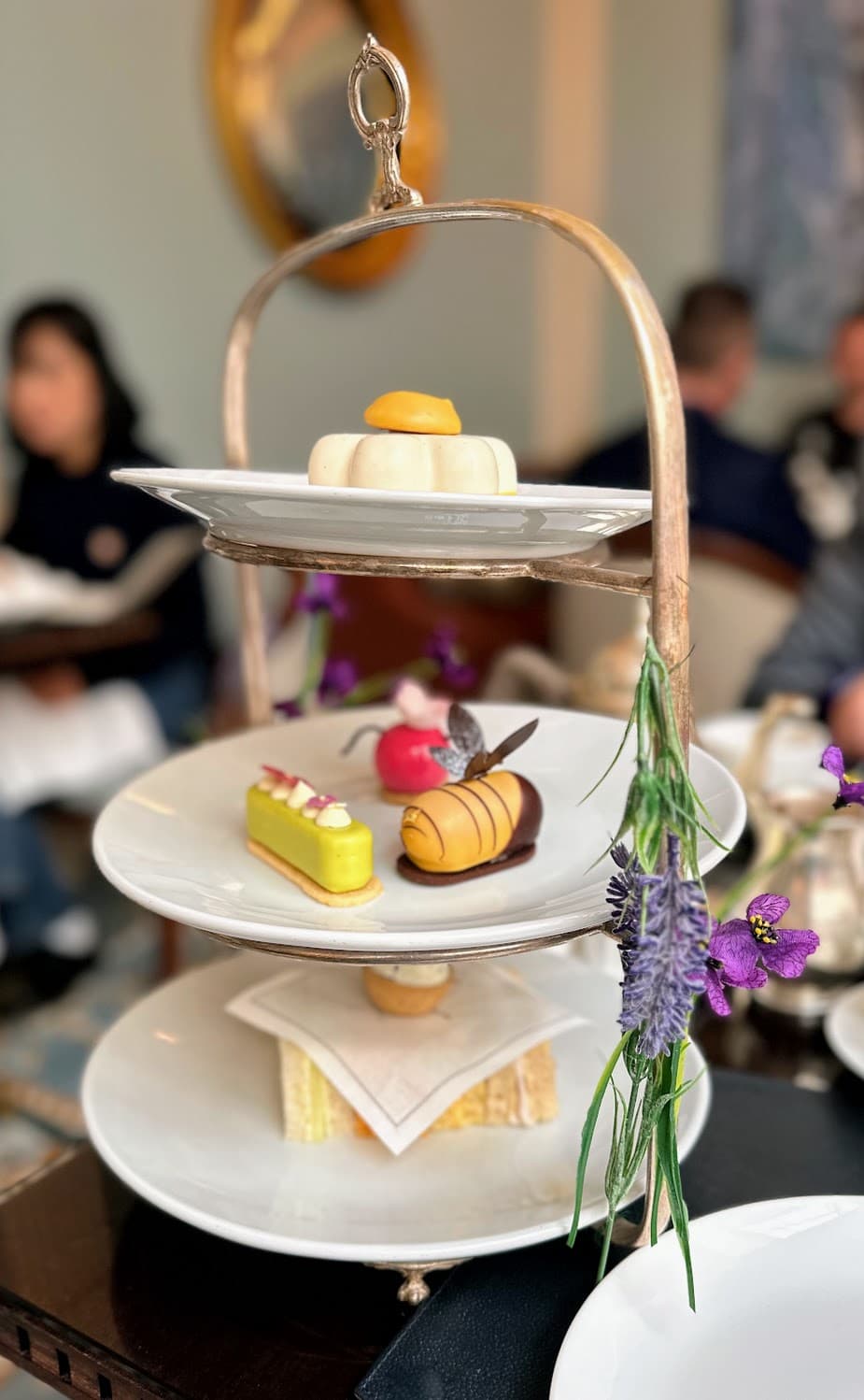 A tiered plate with a selection of mini desserts.