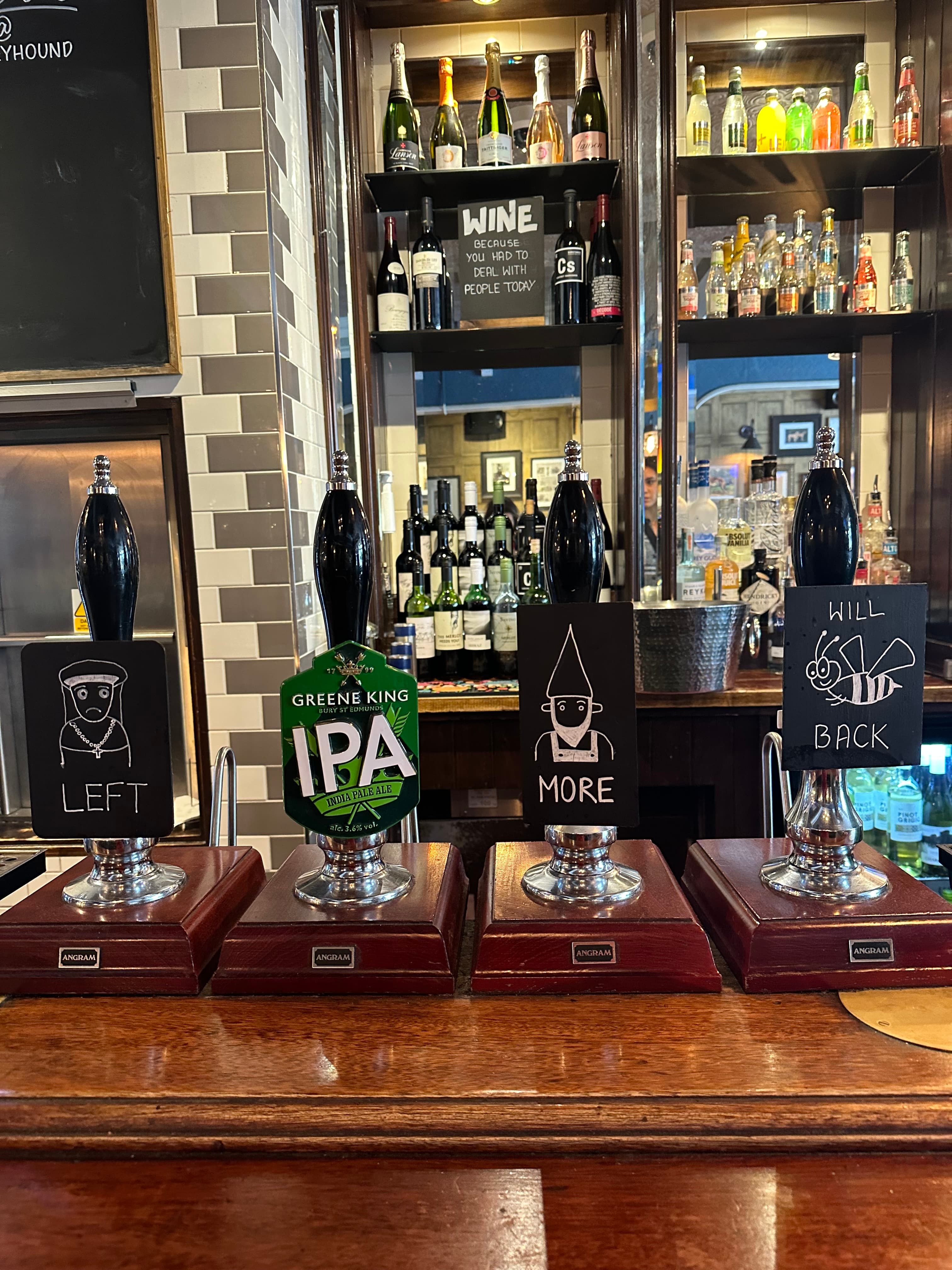 A picture of the bar with different beer taps.