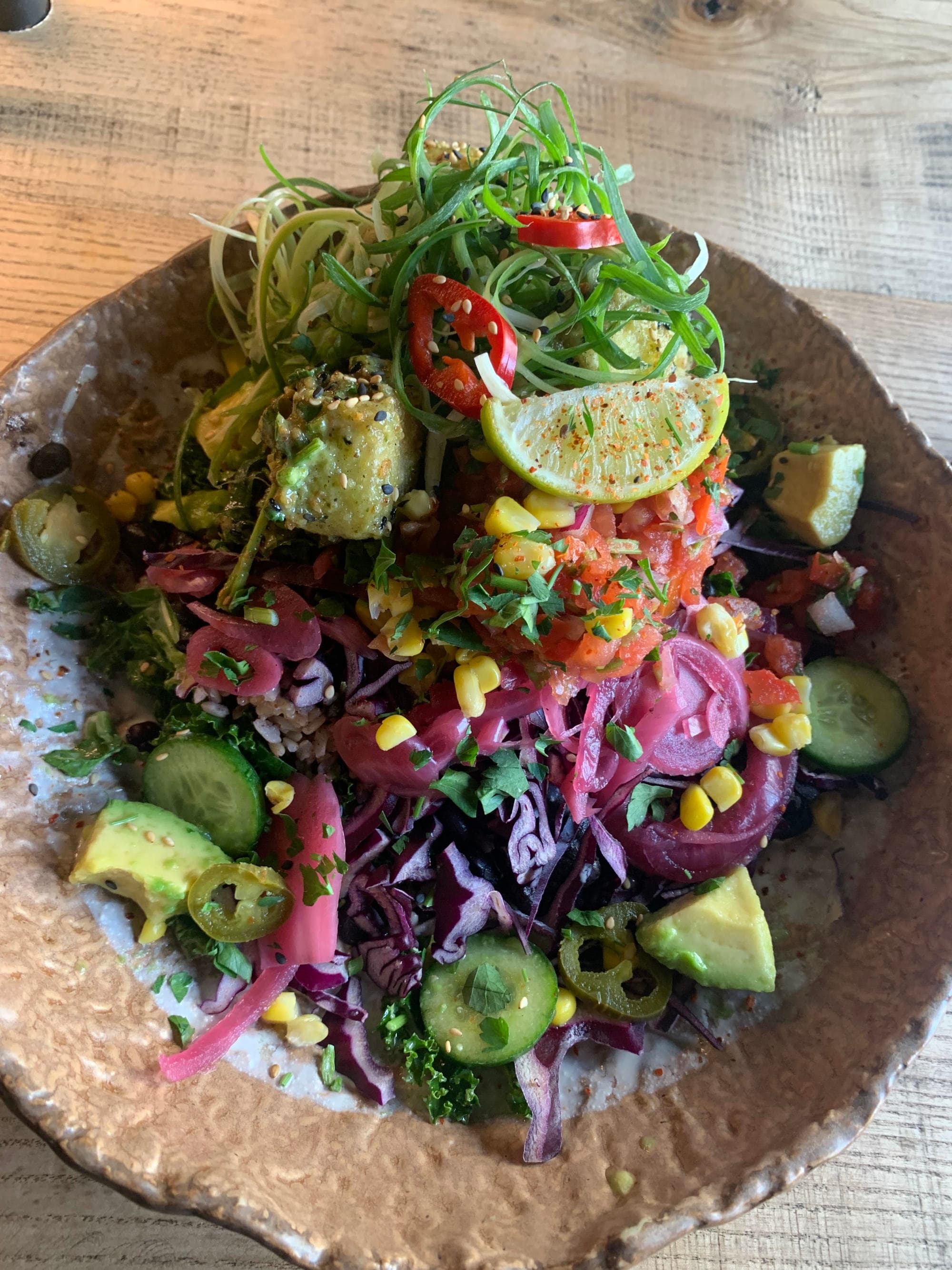 A salad bowl with a colorful arrangement of vegetables.