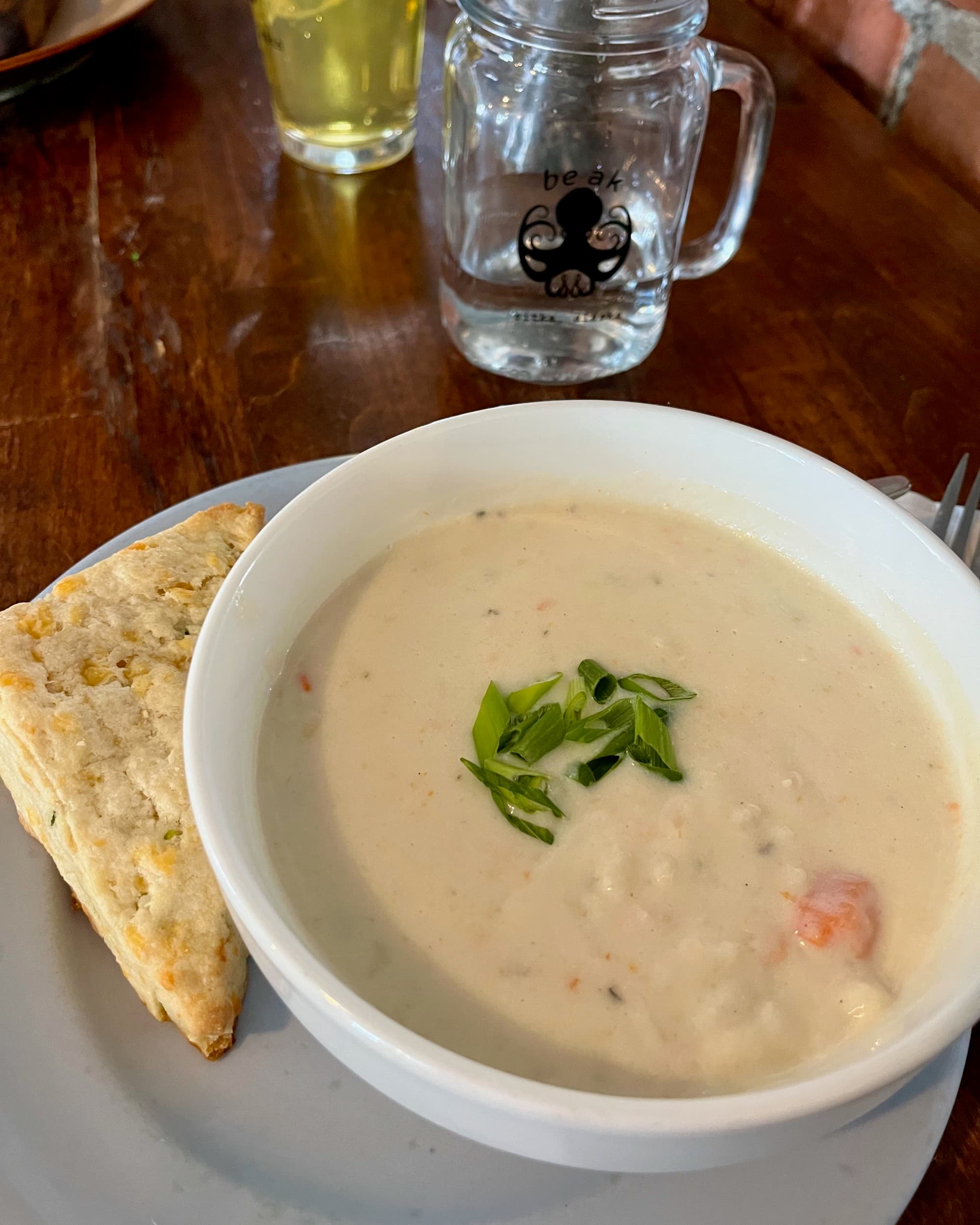 A bowl of salmon chowder with parsley on top.